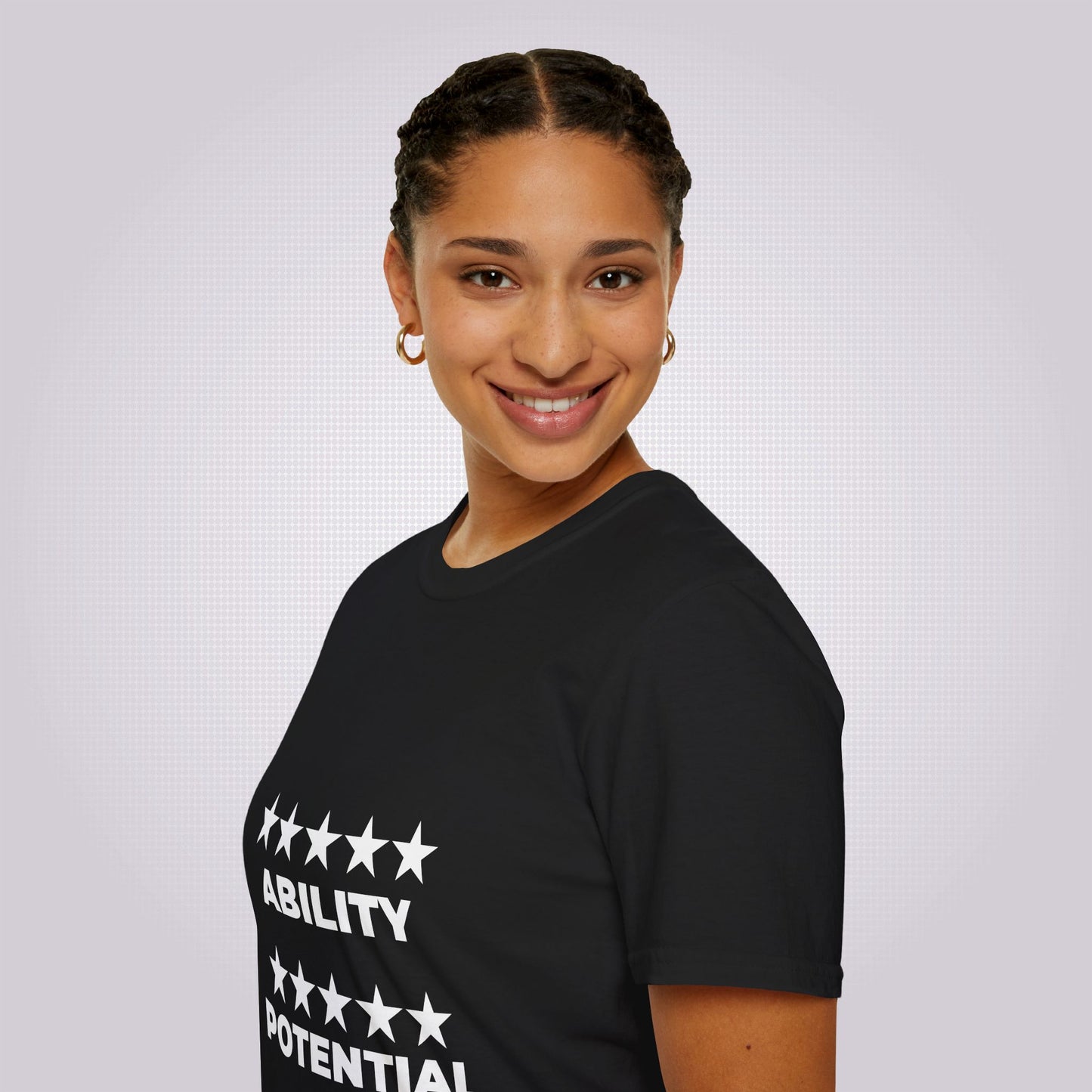 Side profile picture featuring an attractive young mixed race girl in her twenties with her body facing to the left as you look but her face is turned towards the camera and she is modelling the black t shirt
