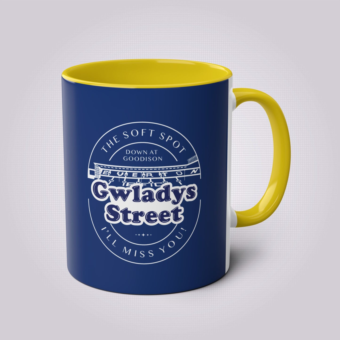 Navy blue mug with yellow handles and inners the handle is on the right hand side.