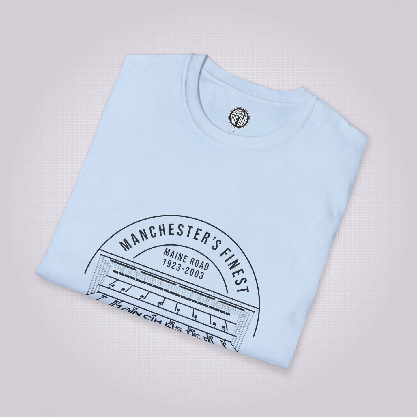 Light blue t shirt folded and placed at a slight right angle on a light grey dotted background