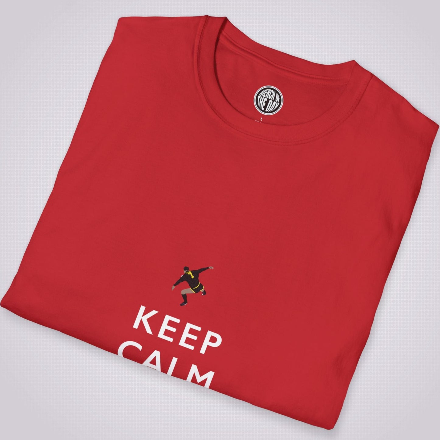 Red T shirt folded and placed at a slight right angle on a light grey dotted background