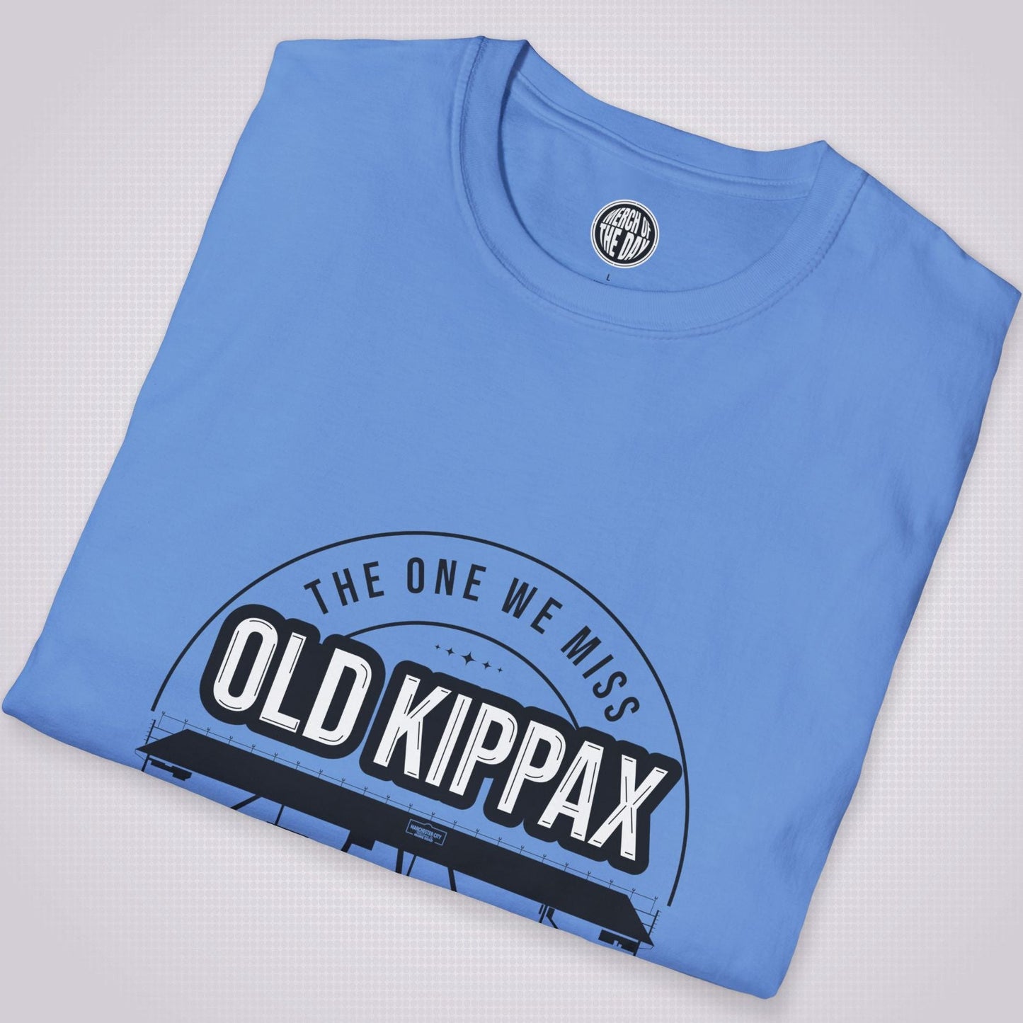 Mid Blue T Shirt placed at a slight right angle on a light grey dotted background