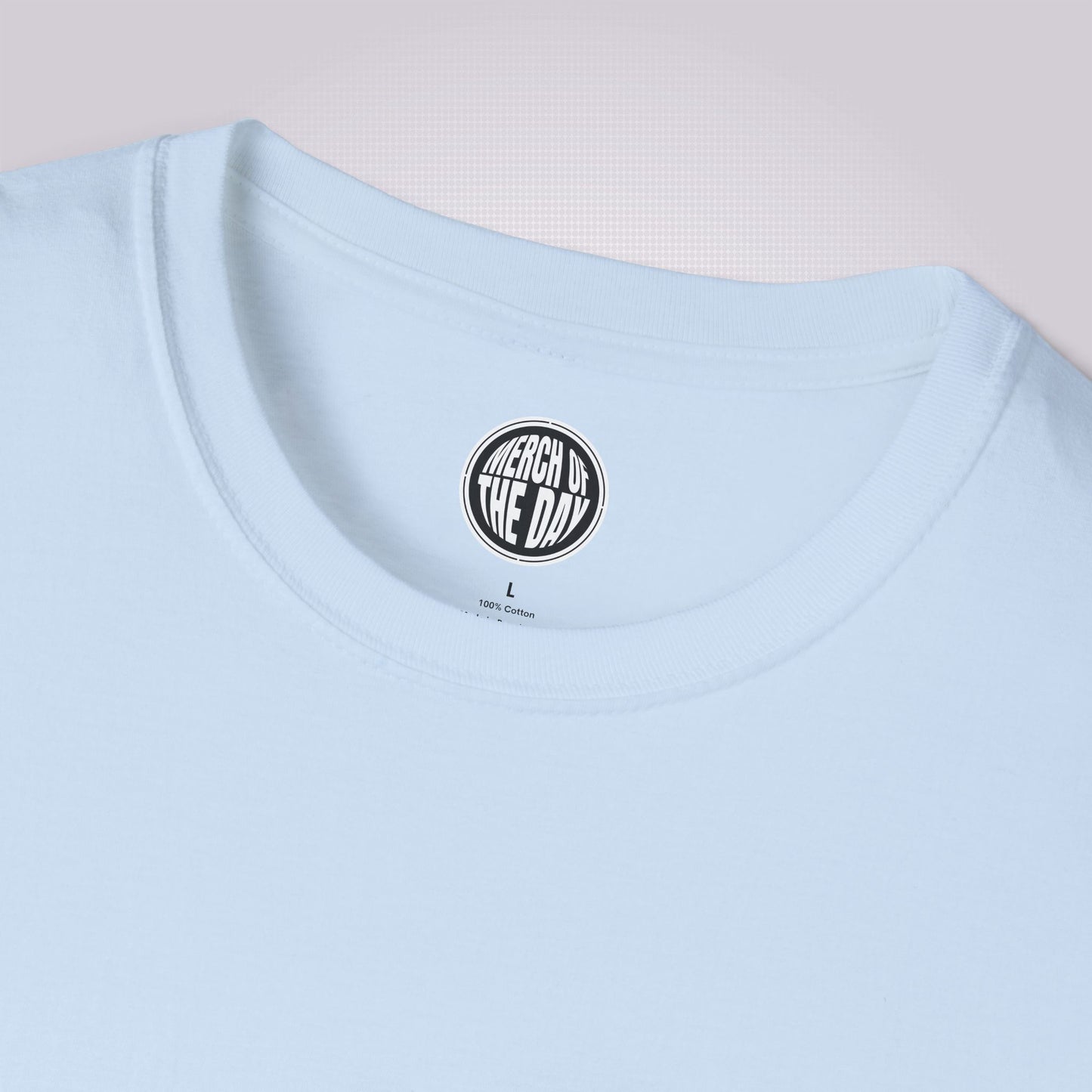 Close up of light blue t shirt showing the crew neckline and the clothing brand logo on the inner label