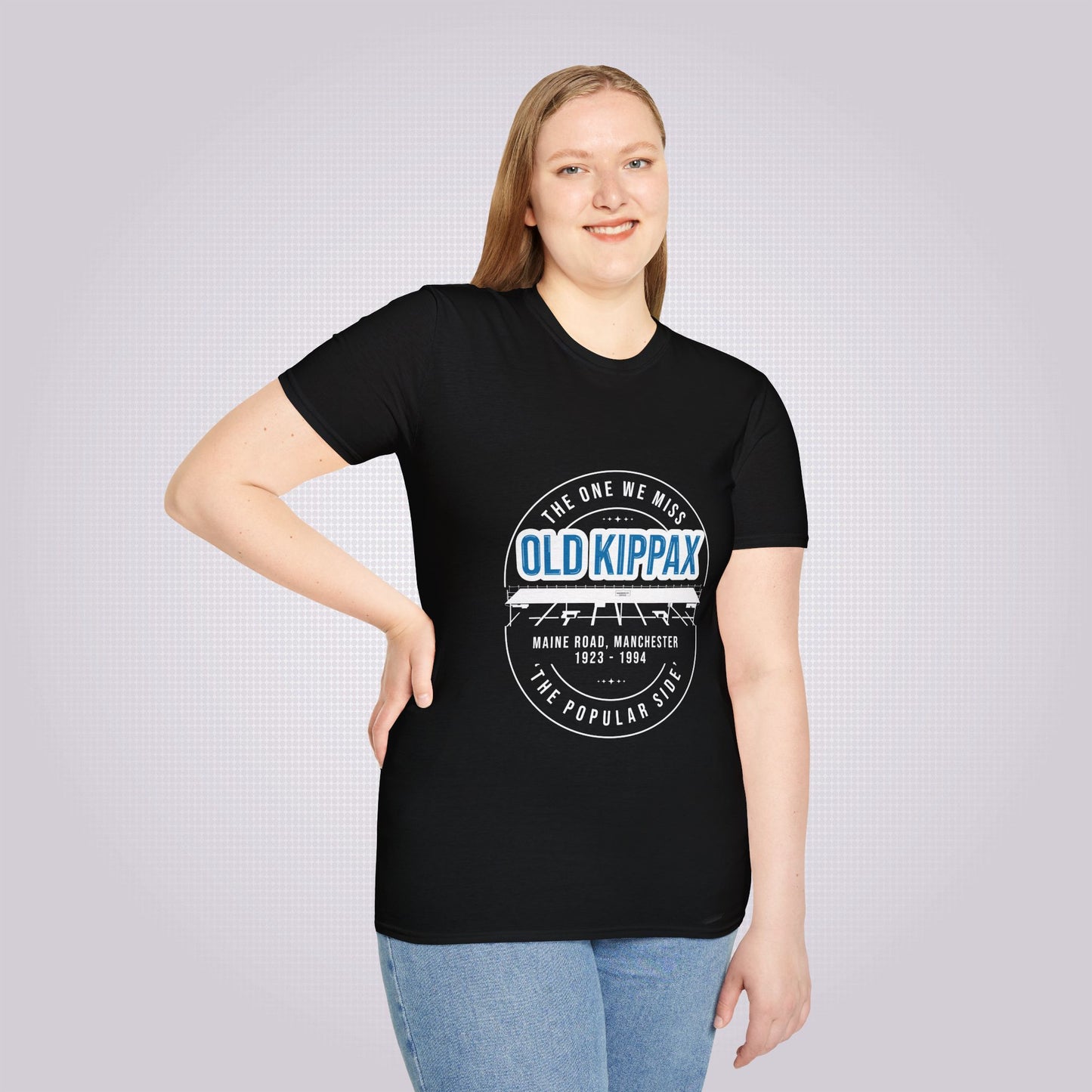 Young woman in her twenties models the black t shirt with a pair of jeans she is smiling at the camera and has one hand on her hip while the other one is by her side