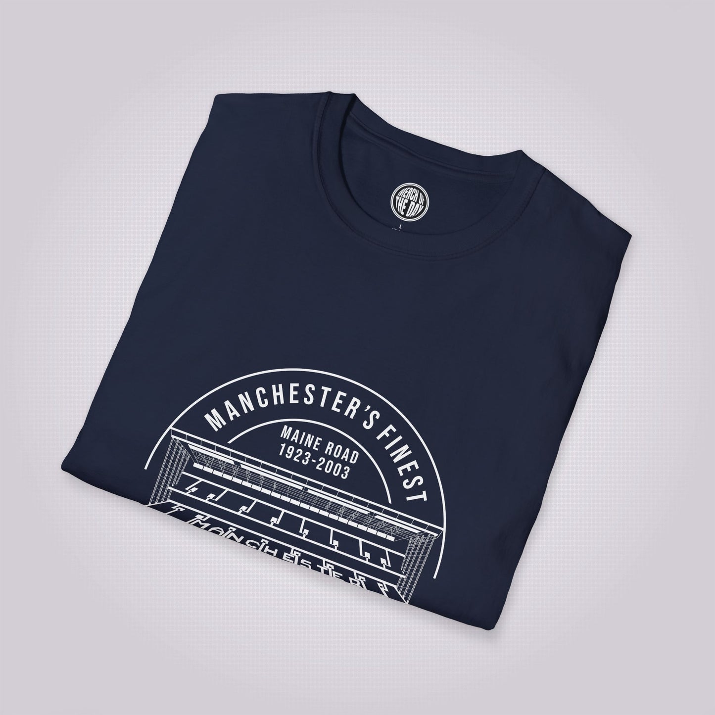 Navy shirt folded up and placed at a slight right angle on a light grey dotted background