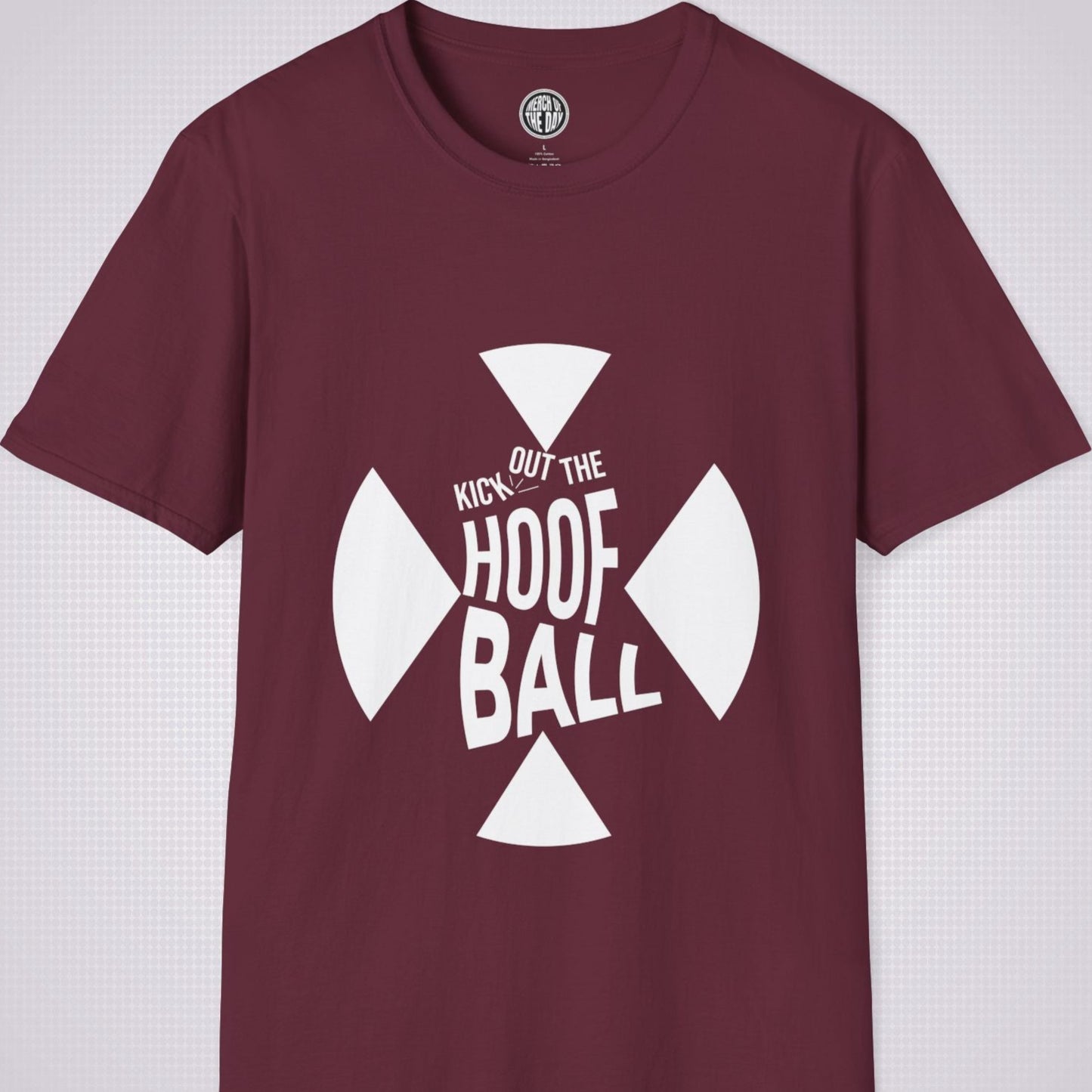 Maroon t shirt on a light grey dotted background. The t shirt has a graphic of a giant X within that are the words 'Kick Out The Hoof Ball'