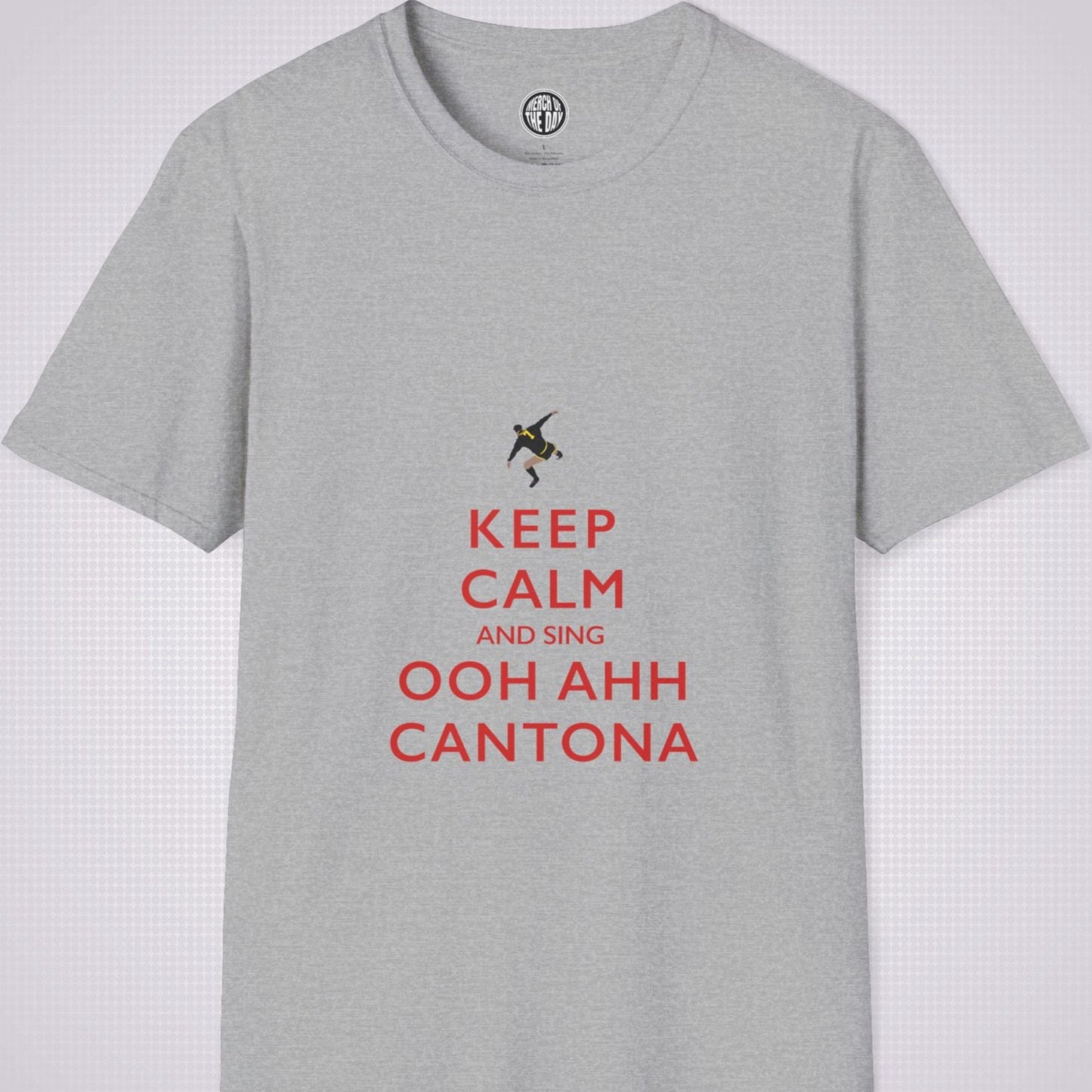 Sport Grey T Shirt on a light grey dotted backdrop. The design on the shirt is done in the keep calm style which reads 'Keep Calm And Sing Ooh Ahh Cantona' in red text, with a cartoon graphic of Eric's famous kung fu kick above it.