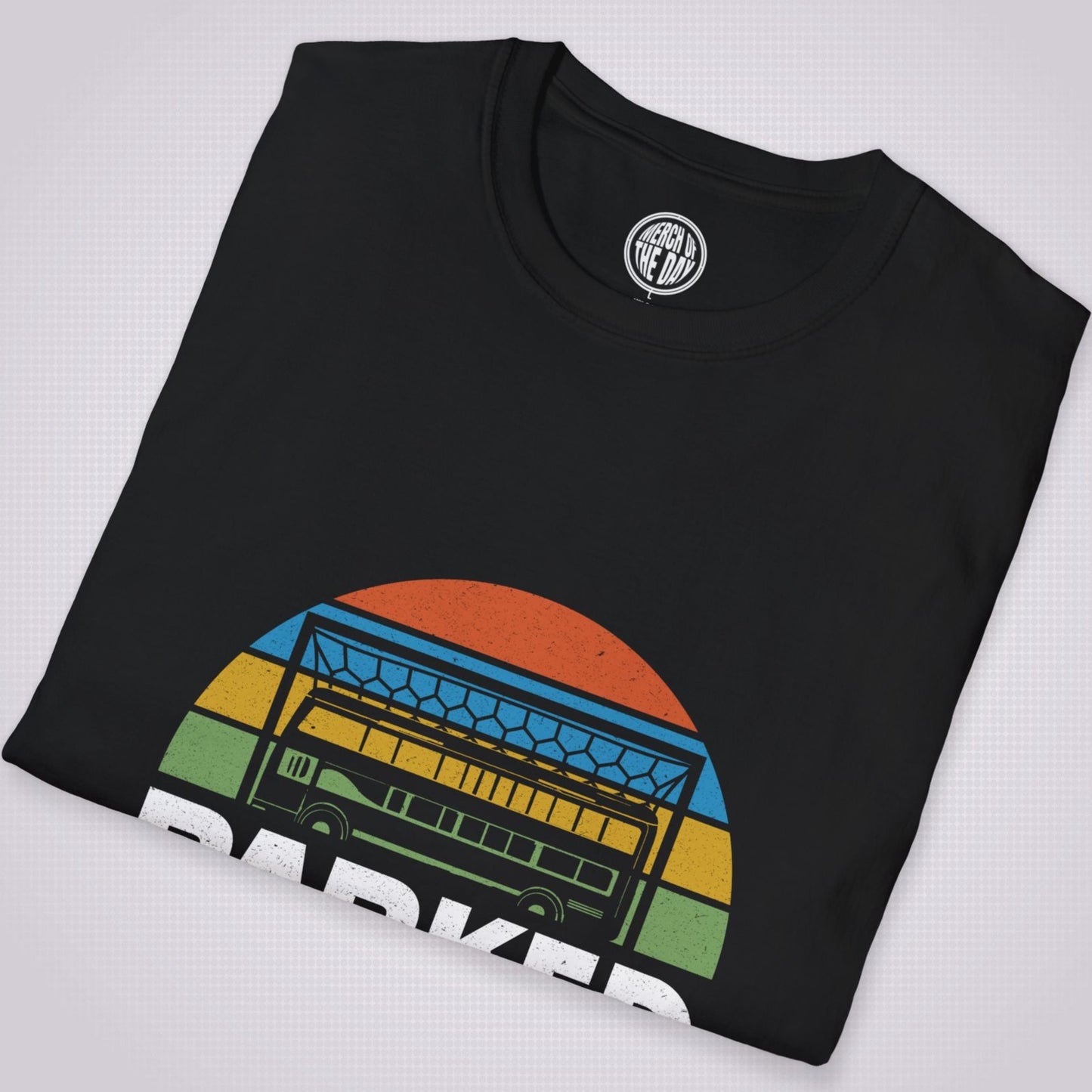 Black T Shirt folded and placed at a slight right angle on a light grey dotted background
