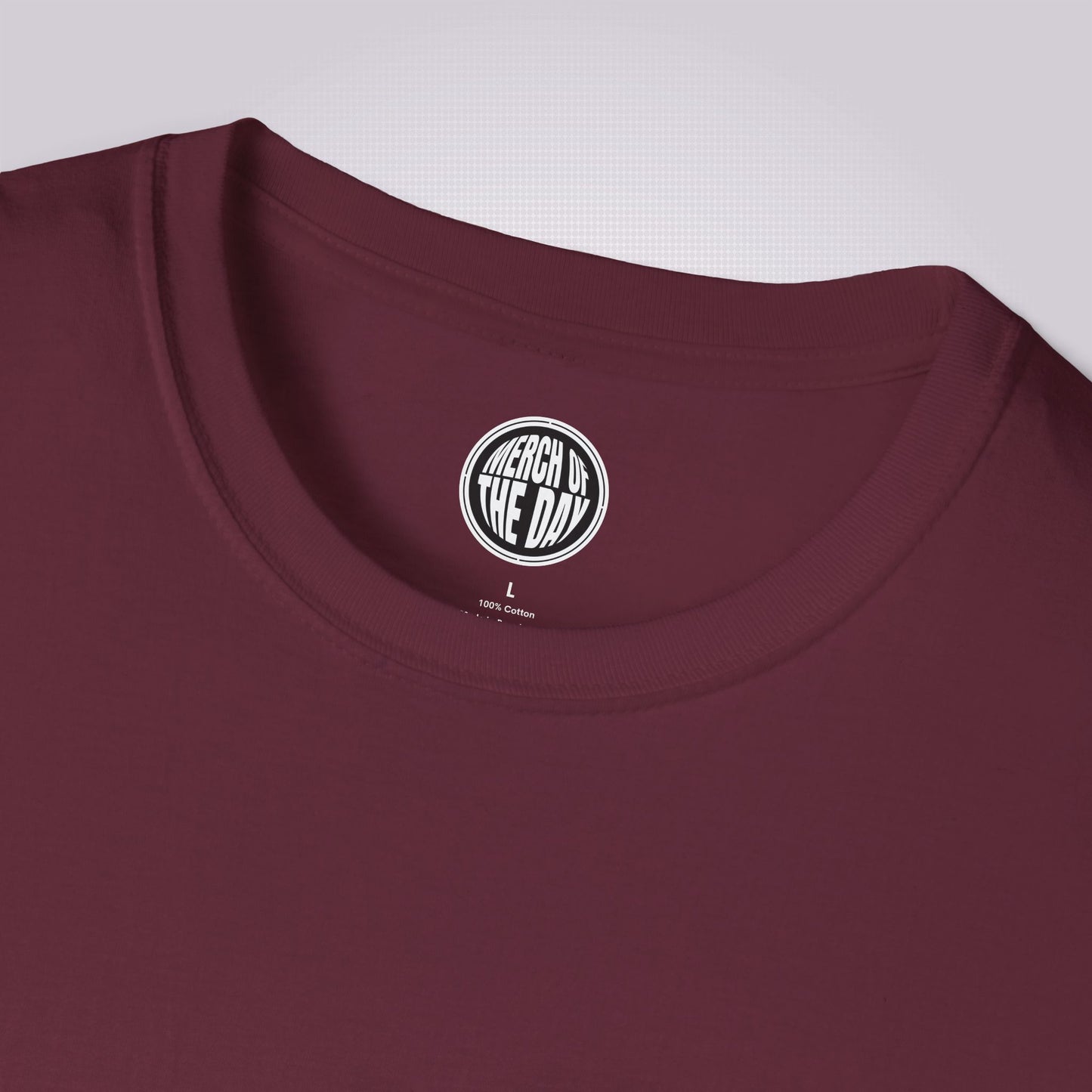 close up of maroon t shirt showing the crew neck and the clothing brand on the inner label