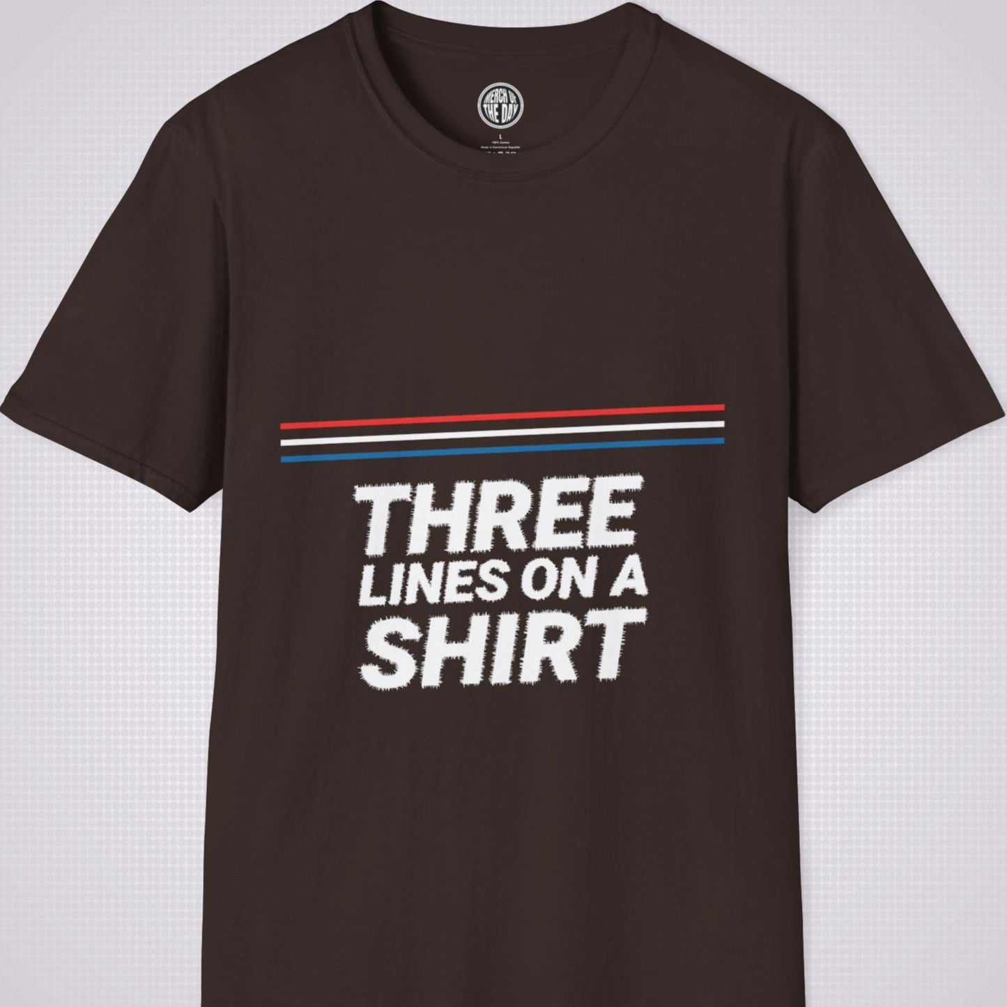 Brown t shirt on a light grey dotted backdrop with a red white and blue diagonal line pattern with the words three lines on a shirt under that