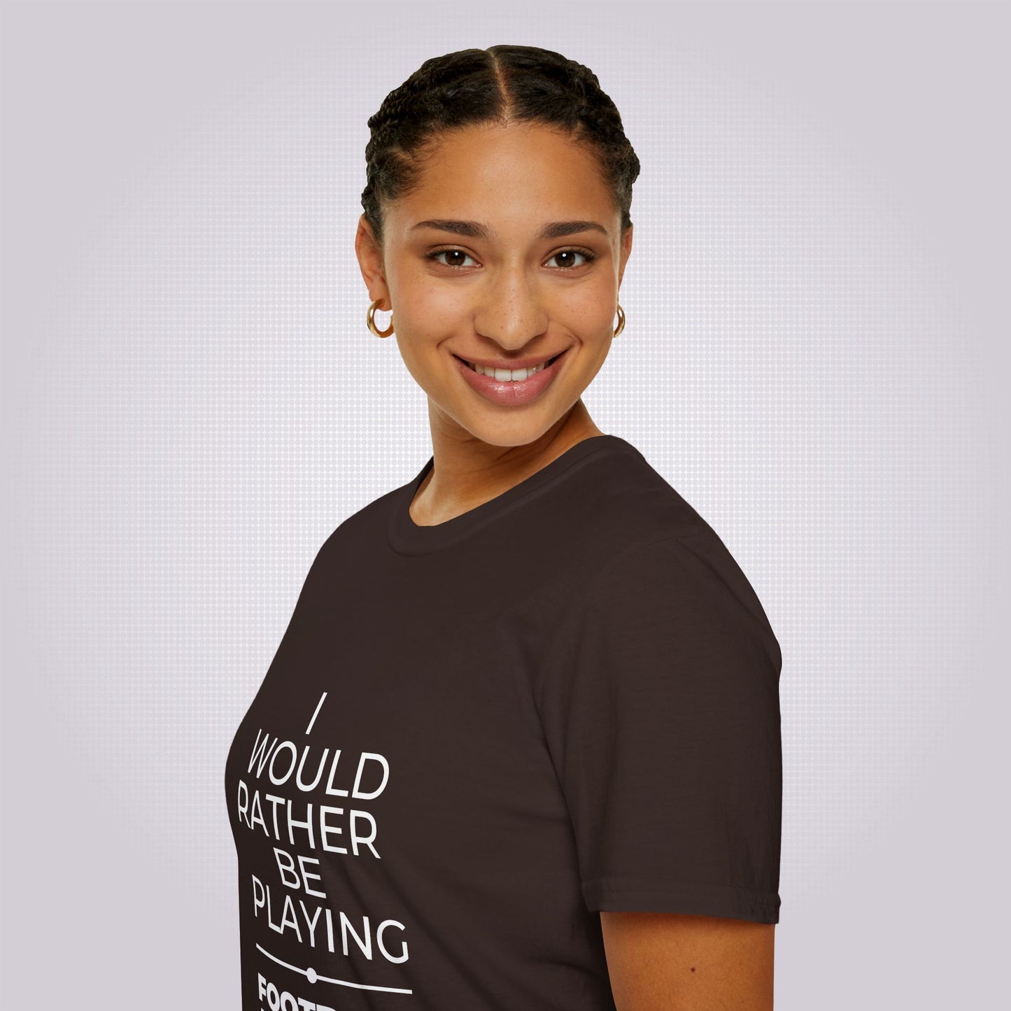 Side profile shot of an attractive mixed race woman wearing the brown t shirt her body is facing to the left as you look but she has her head turned to smile at the camera