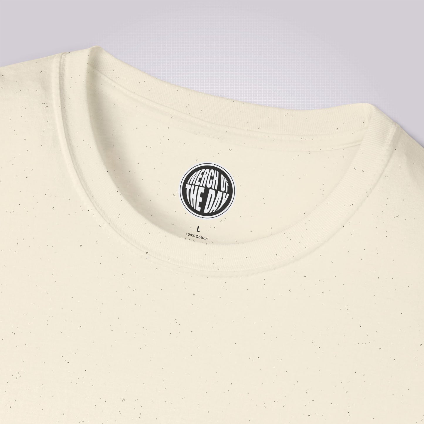 Close up of cream t shirt showing the black flecks which form part of the fabric. Showcases the crew neckline and the clothing brand logo on the inner neck label