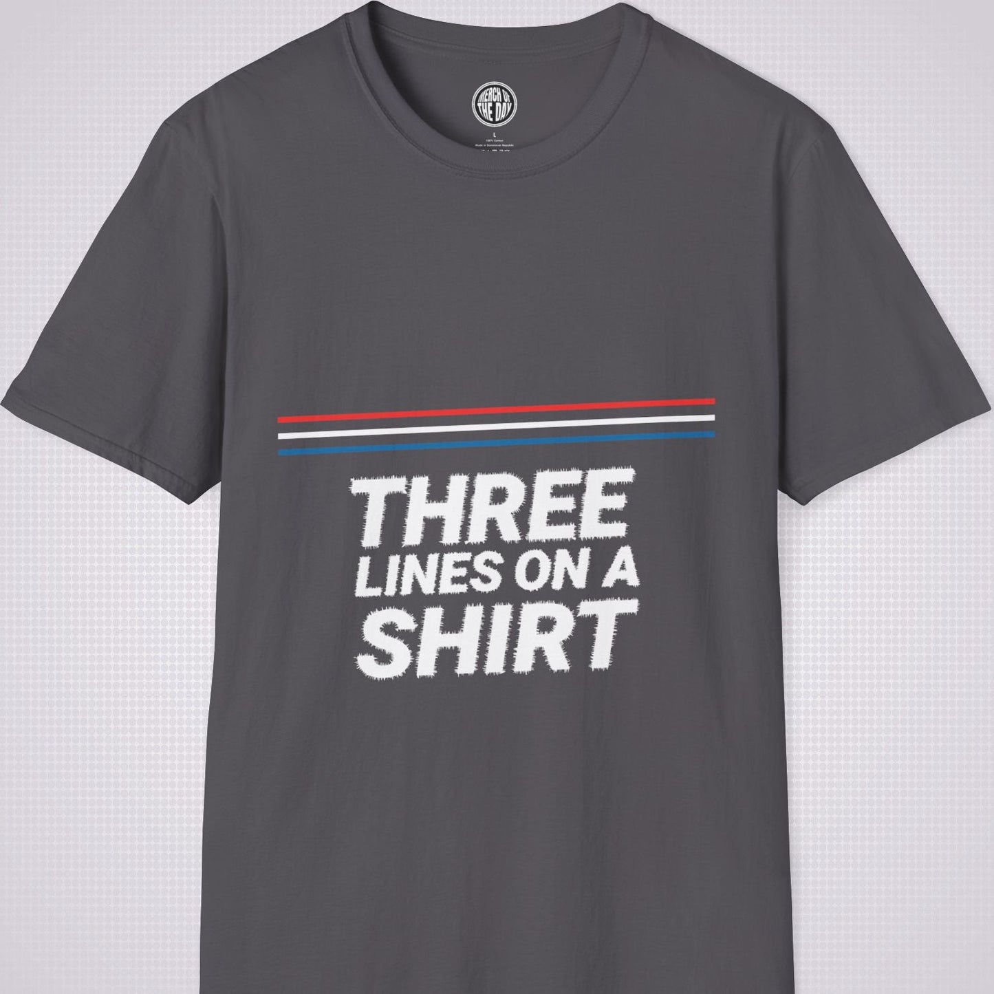 Charcoal t shirt on a light grey dotted backdrop with a red white and blue diagonal line pattern with the words three lines on a shirt under that