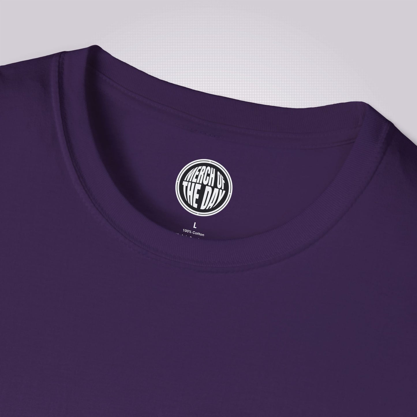 close up of purple t shirt showing the clothing brand logo on the inner label