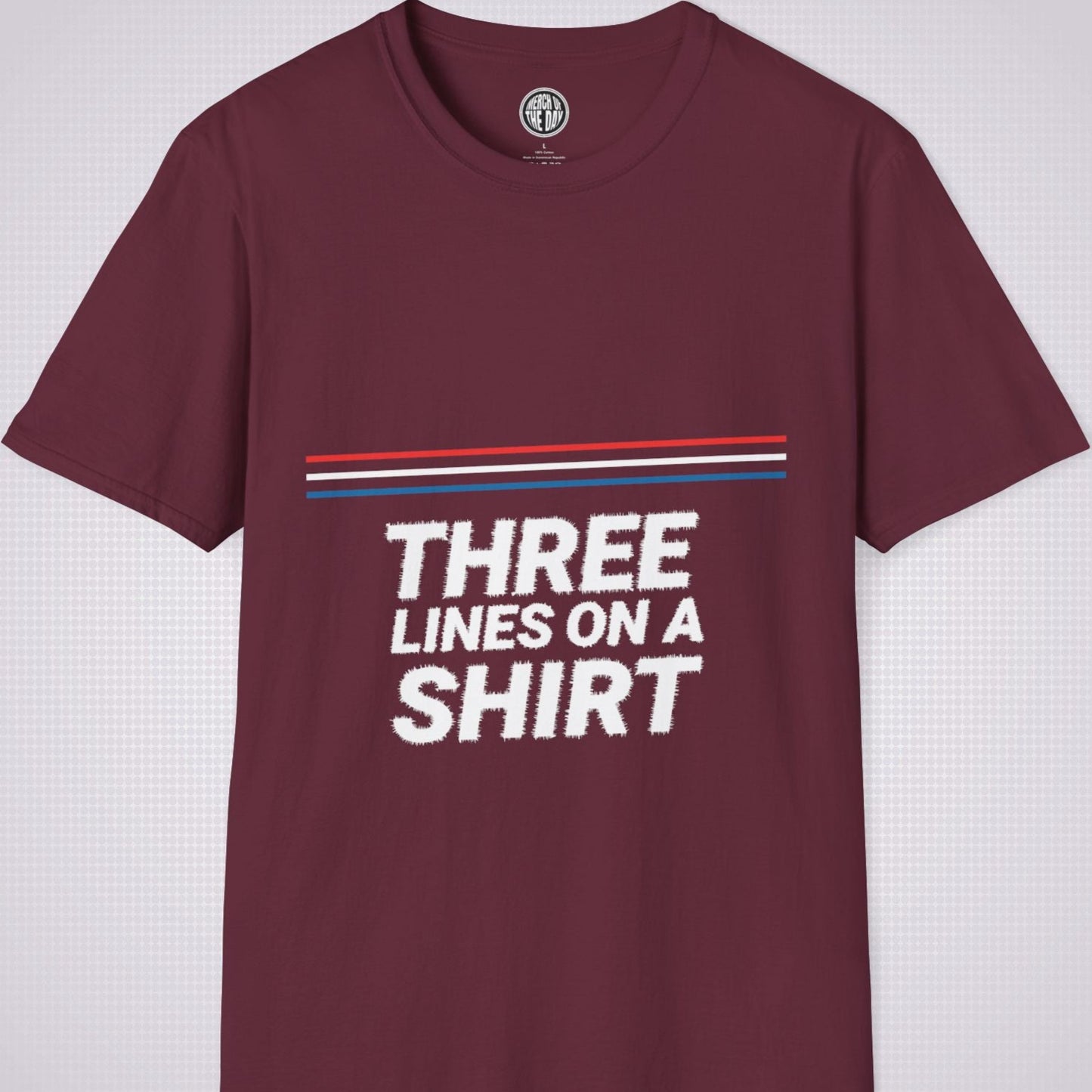 Maroon t shirt on a light grey dotted backdrop with a red white and blue diagonal line pattern with the words three lines on a shirt under that