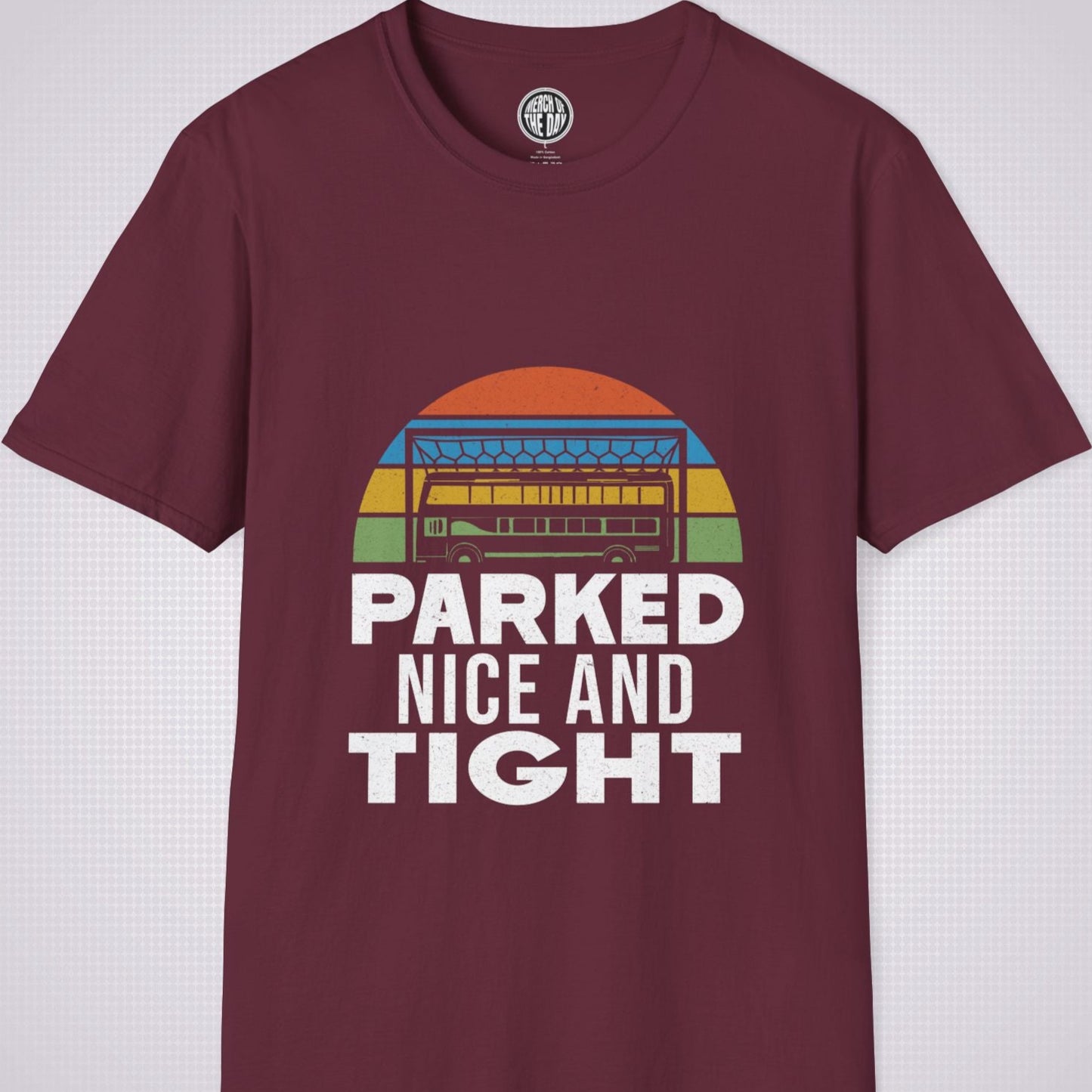 Maroon T Shirt on a light grey dotted background the graphic shows a distressed sunset with a football goalpost with a bus packed into it and the phrase parked nice and tight