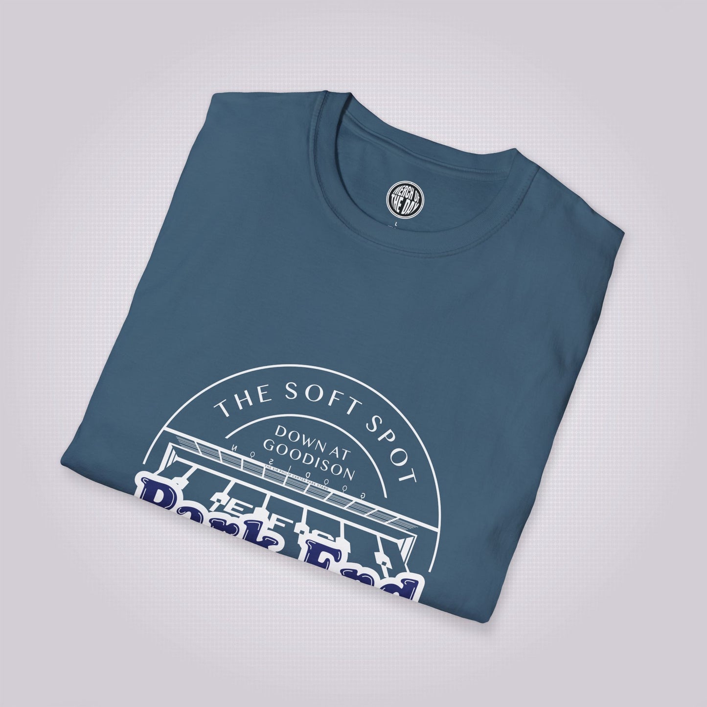 Indigo blue t shirt placed at a slight right angle on a light grey dotted background