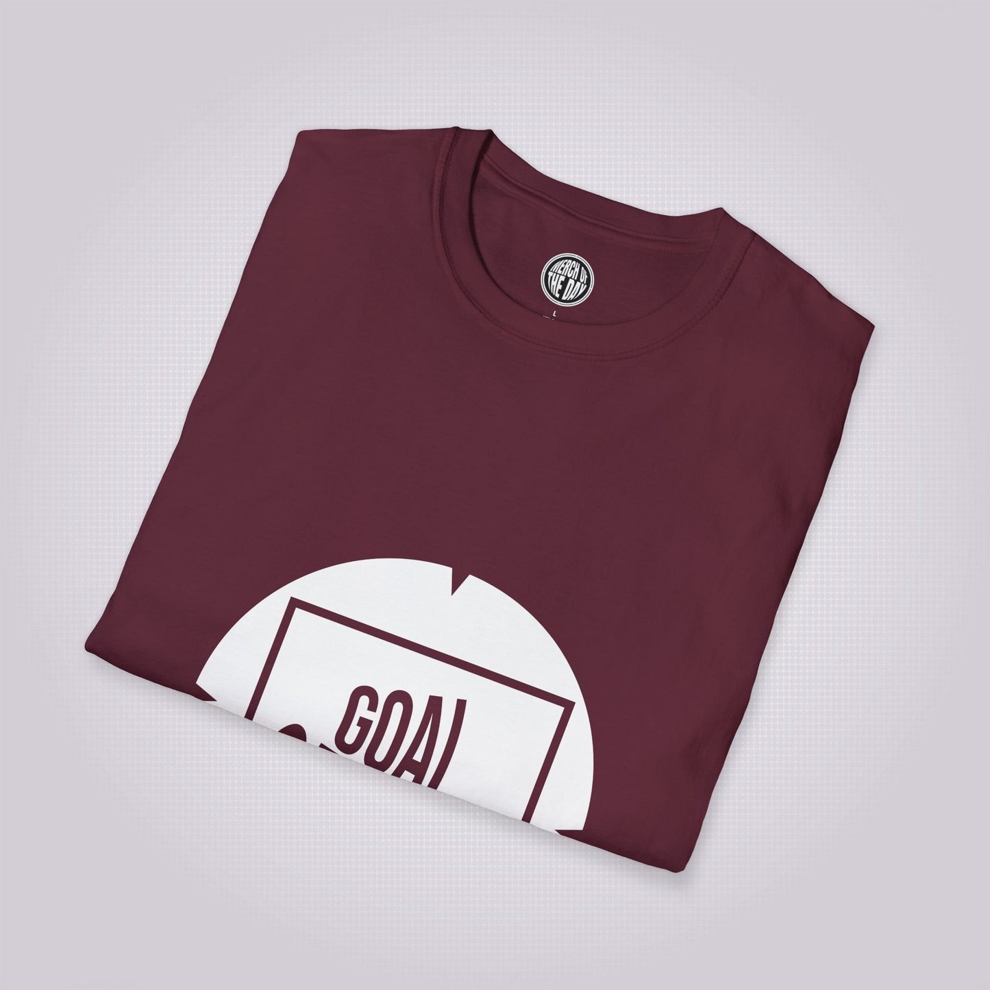 maroon t shirt folded and placed at a right angle showing the top half of the shirt graphic and the clothing brand logo on the inner neck label