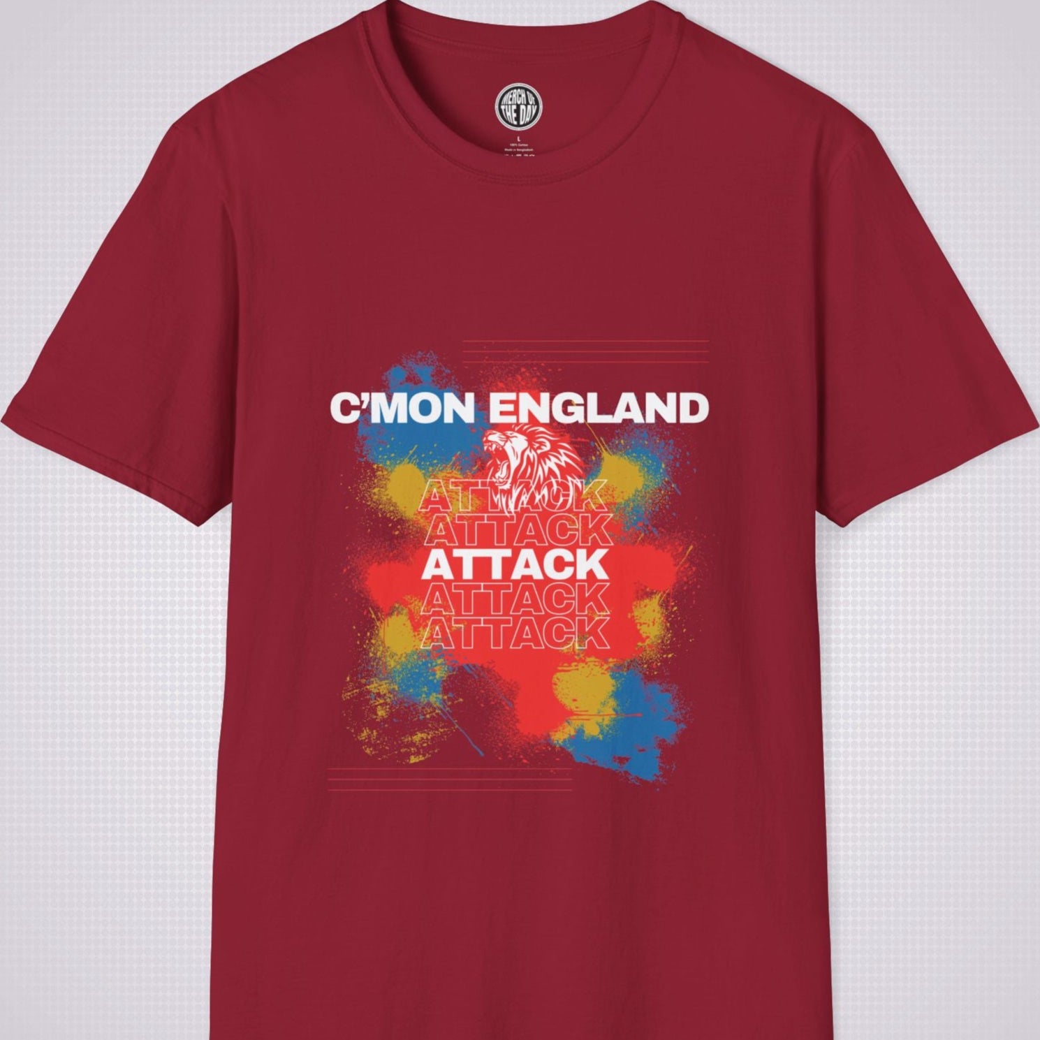 Red t shirt on a light grey background with an explosion of red yellow and blue with a white lion roaring and the words cmon england attack 