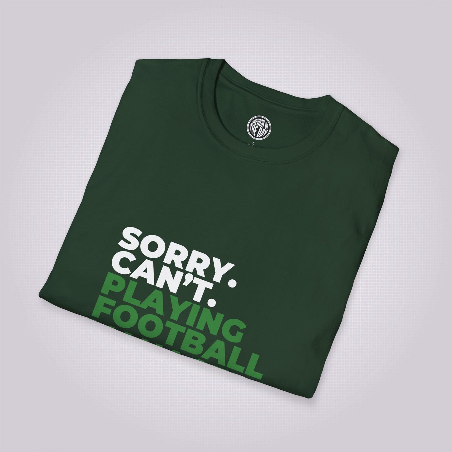 Green shirt folded up and placed at a right angle showing the top section of the shirt graphic