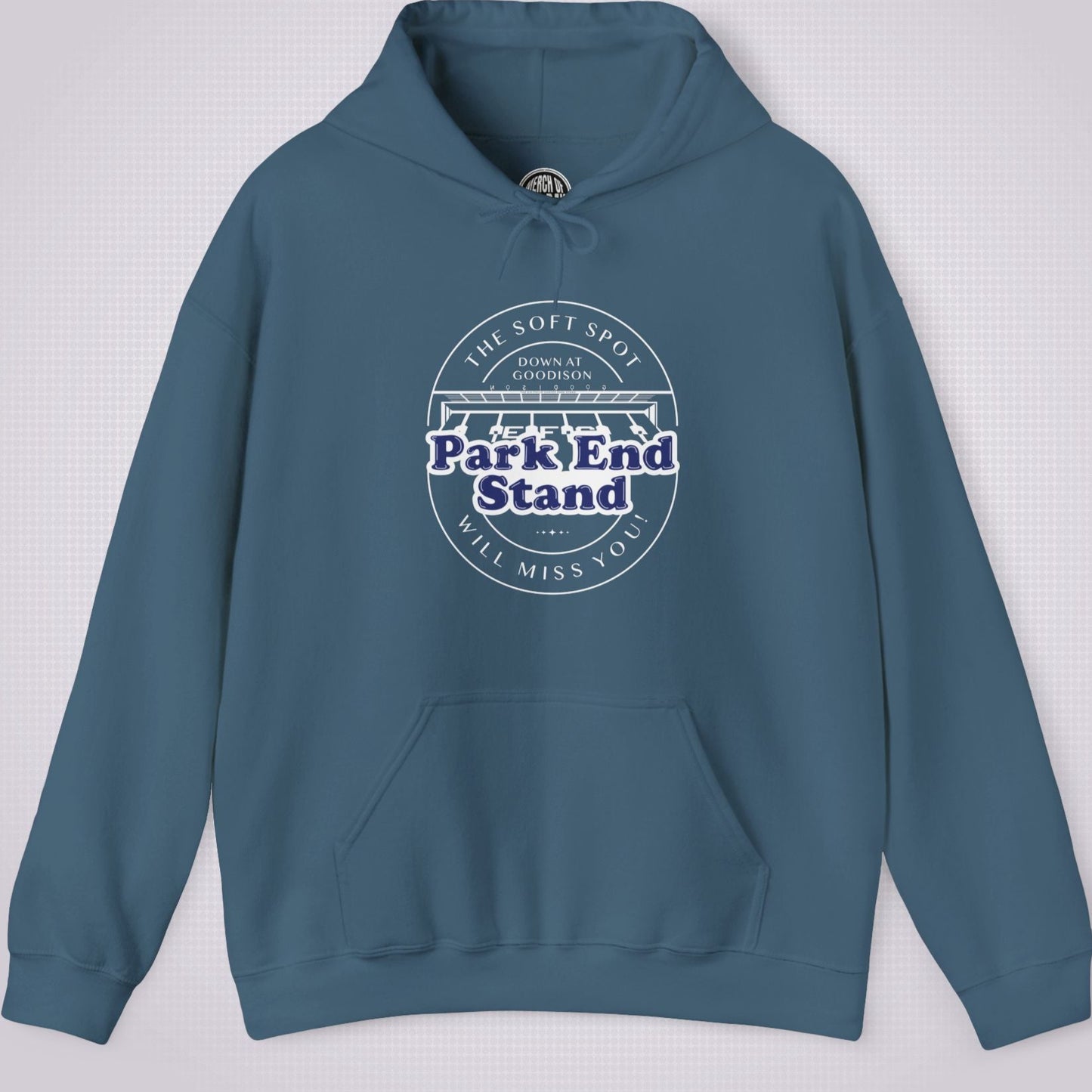 Indigo Blue hoodie on a light grey dotted background the artwork on the clothing shows an illustration of the Park End Stand at Goodison Park. Above the illustration are the words 'The Soft Spot' in a downward facing arc, under that it says 'Down at Goodison'. Underneath the illustration it reads "Park End Stand" in bold blue letters with a white fill behind it to make it stand out, then underneath that it reads 'Will Miss You' in a upward facing arc.