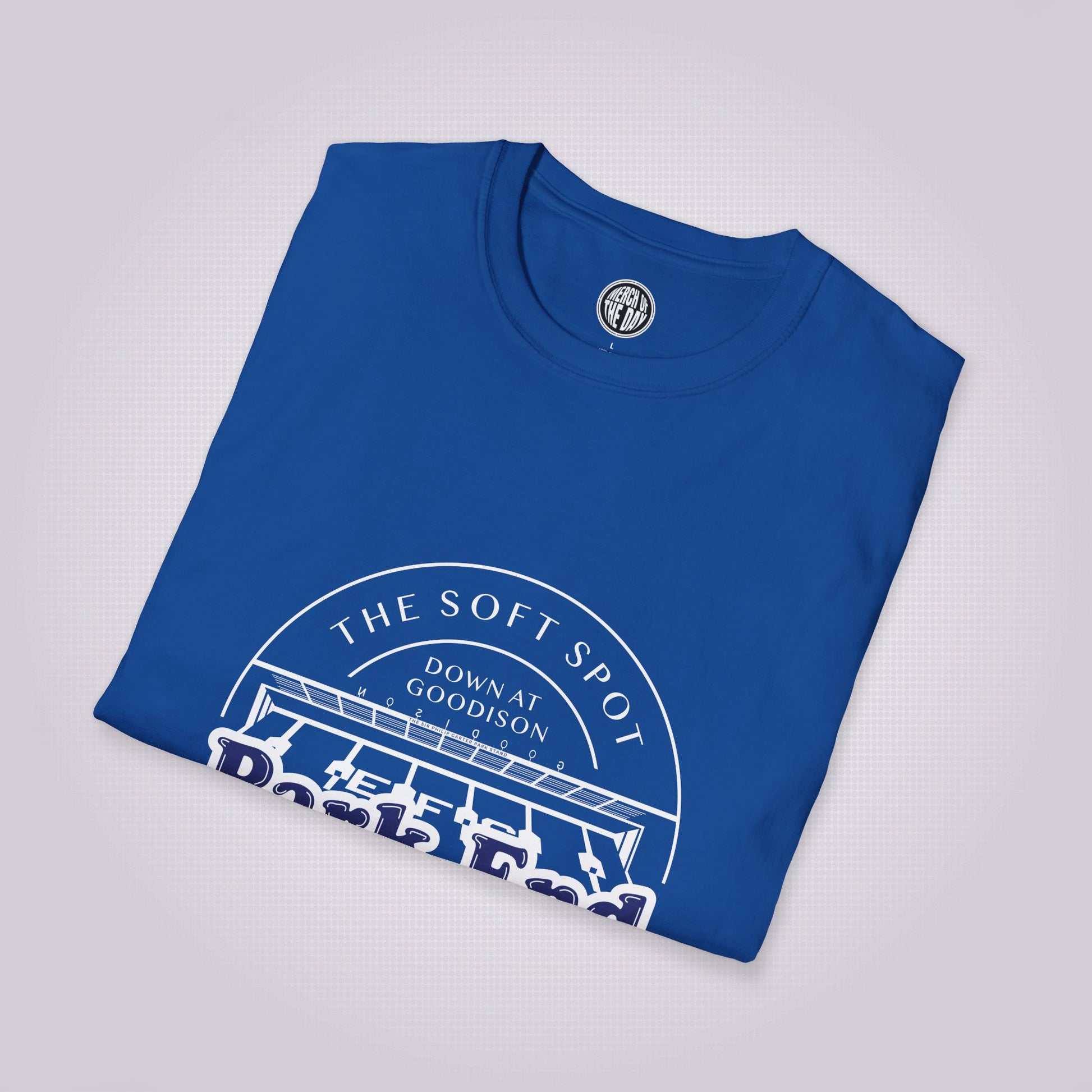 Royal Blue T Shirt placed at a slight right angle on a light grey dotted background