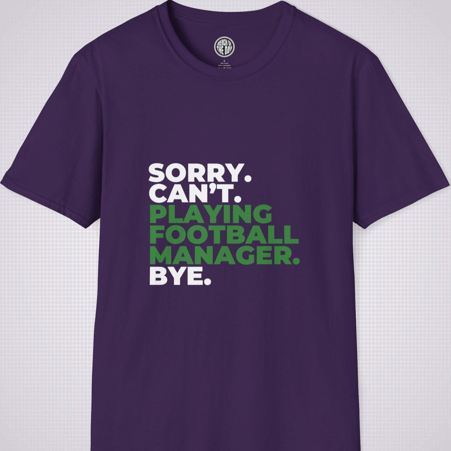 Purple t shirt on a light grey patterned background the text on the shirt reads sorry cant playing football manager bye the words playing football manager are in green the rest are in white