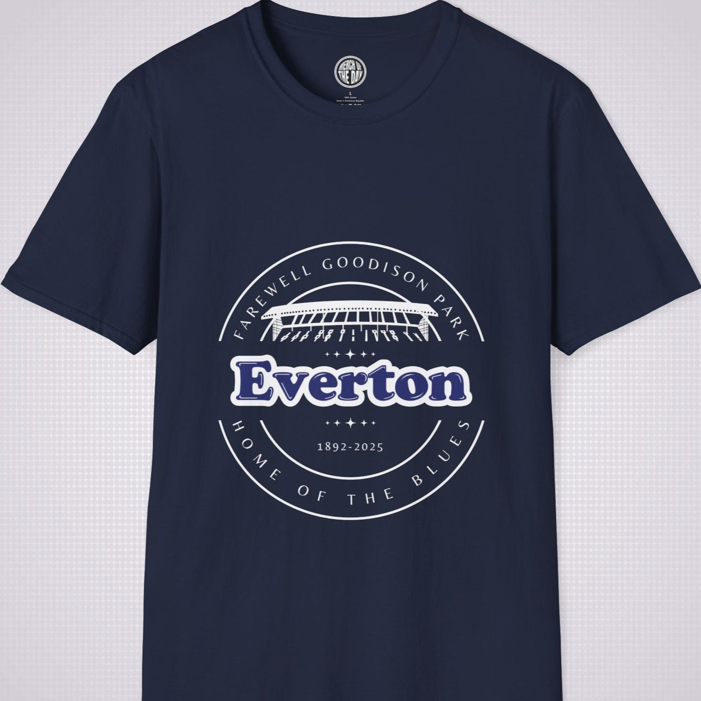 Navy t shirt on a light grey dotted background there is a graphic showing an illustration of the main stand at Goodison Park with the words 'Farewell Goodison Park' written in a downward facing arc above it, below it are the  words 'Everton 1892 to 2025' and then below that are the words 'Home of the blues' written in an upward facing arc