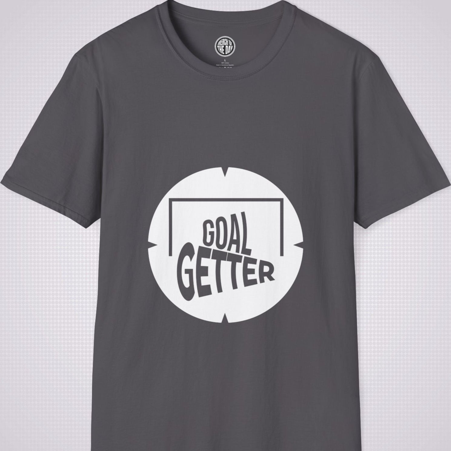 Charcoal t shirt on a light grey patterned background the artwork on the shirt shows a circle with segments in all 4 corners symbolising a target and a football  and the words read goal getter within a goal frame 