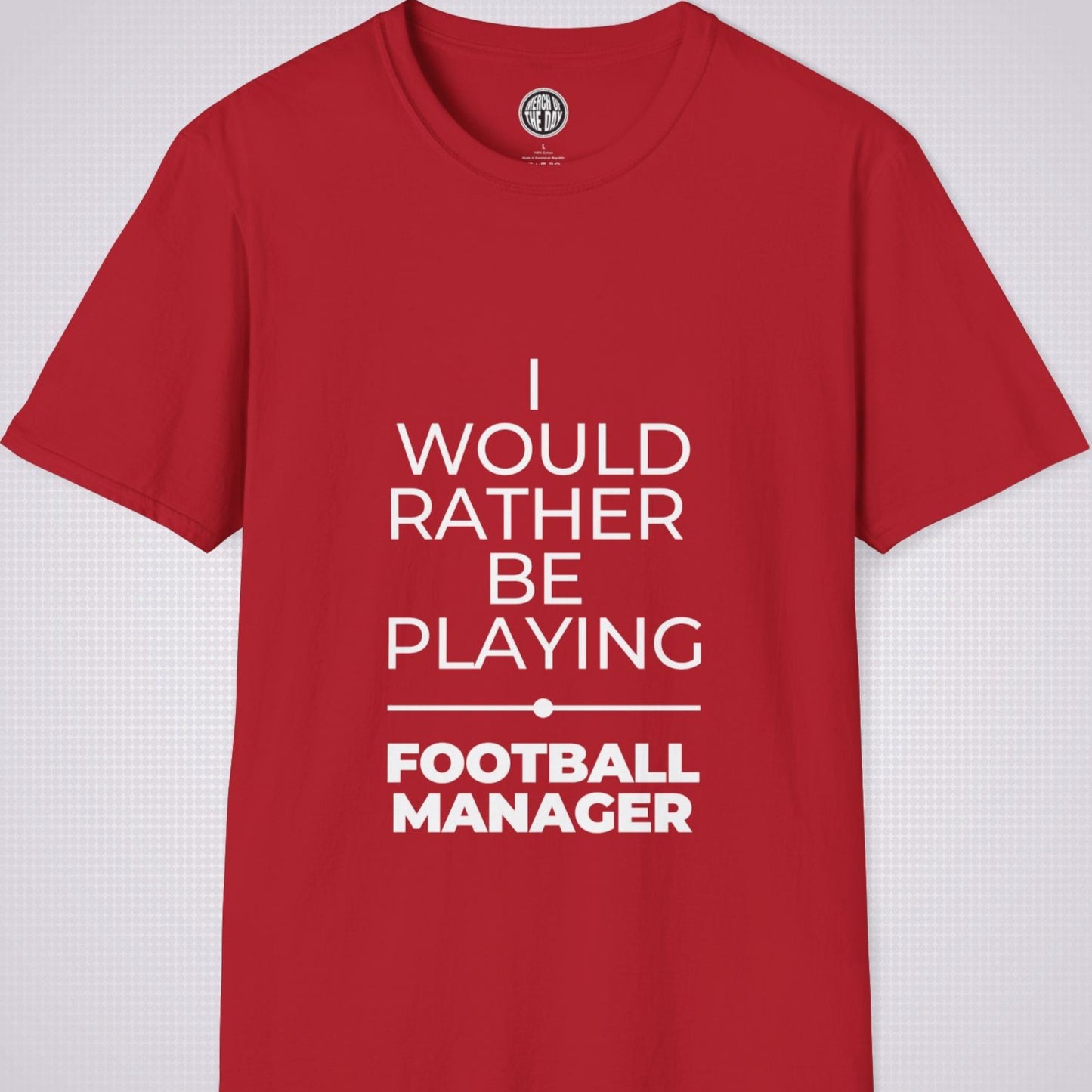 Red t shirt on a light grey patterned backdrop with text on the shirt saying I would rather be playing football manager