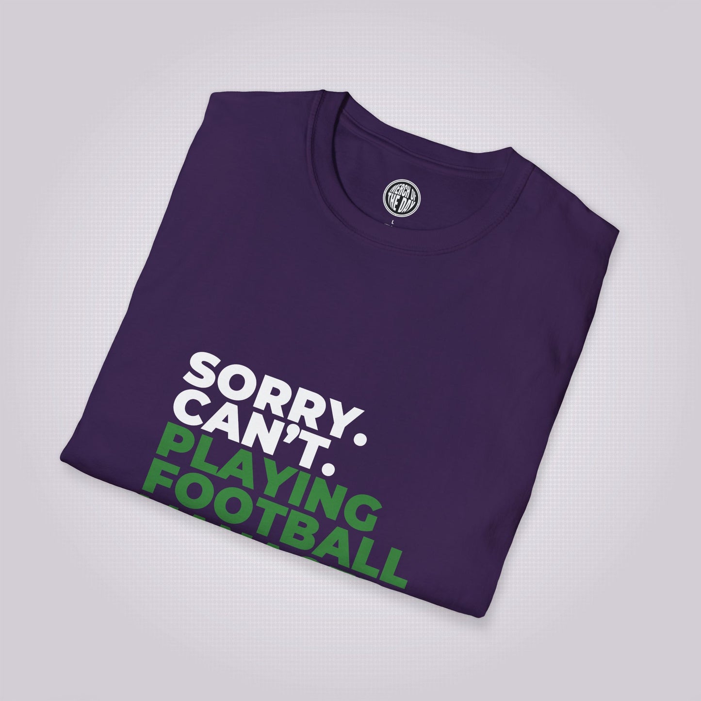 Purple t shirt folded up and placed at a slight angle showing the top section of the shirt graphic