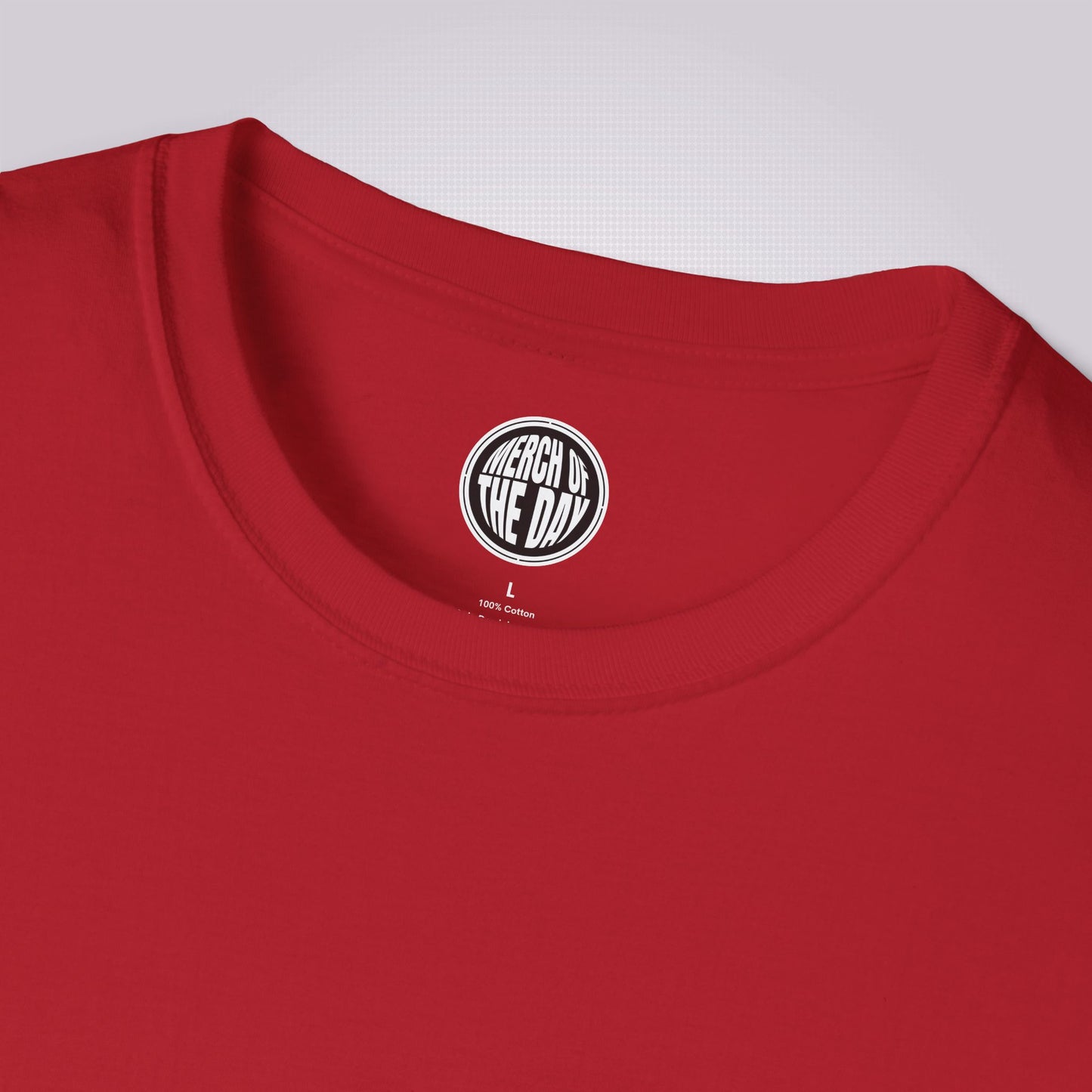 Close up of red t shirt showing the crew neckline and clothing brand logo on the inner neck label