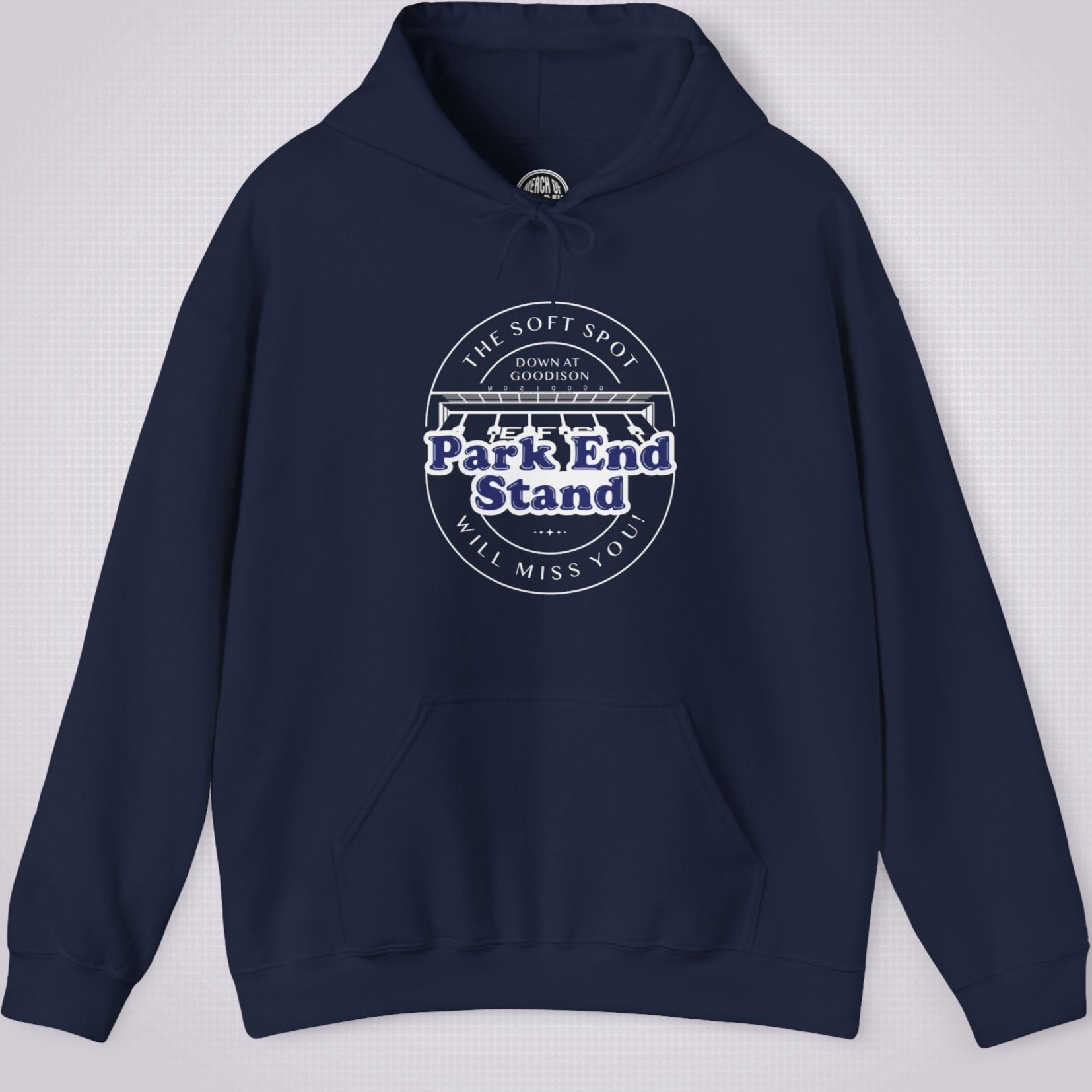 Navy hoodie on a light grey dotted background the artwork on the clothing shows an illustration of the Park End Stand at Goodison Park. Above the illustration are the words 'The Soft Spot' in a downward facing arc, under that it says 'Down at Goodison'. Underneath the illustration it reads "Park End Stand" in bold blue letters with a white fill behind it to make it stand out, then underneath that it reads 'Will Miss You' in a upward facing arc.