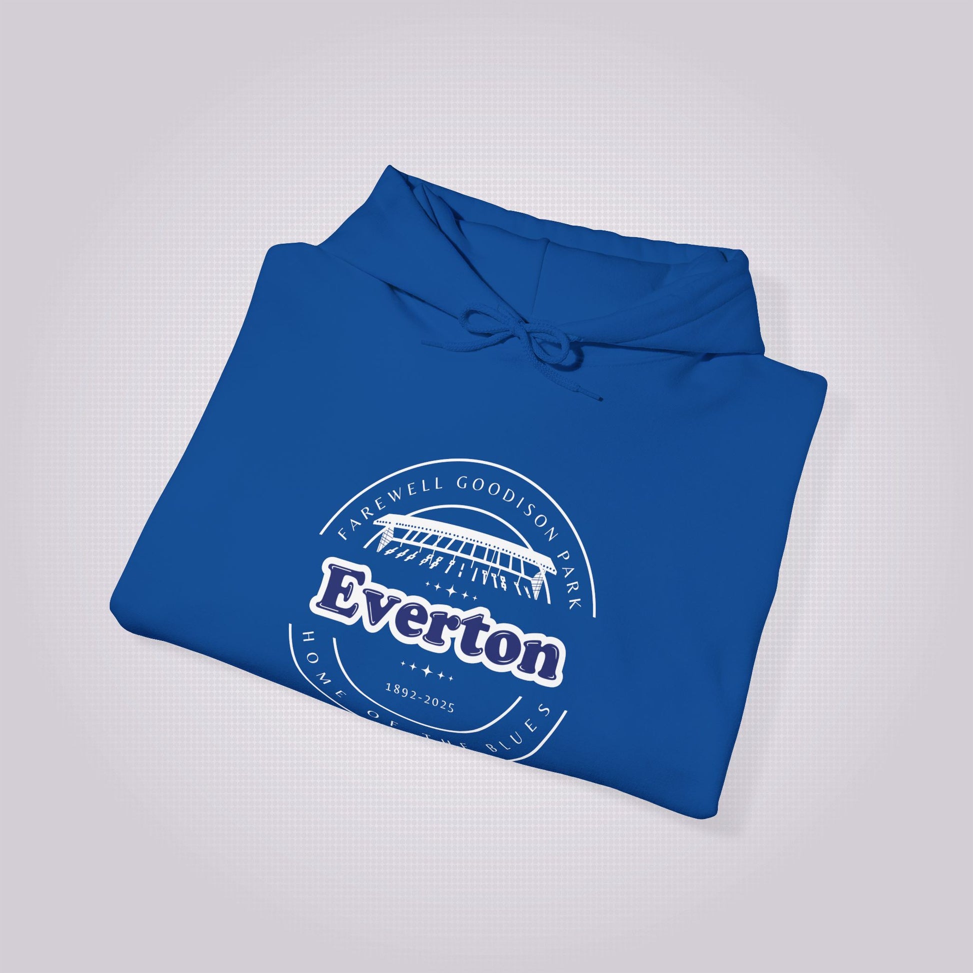 Royal blue hoodie folded up and placed at a slight right angle on a light grey dotted background