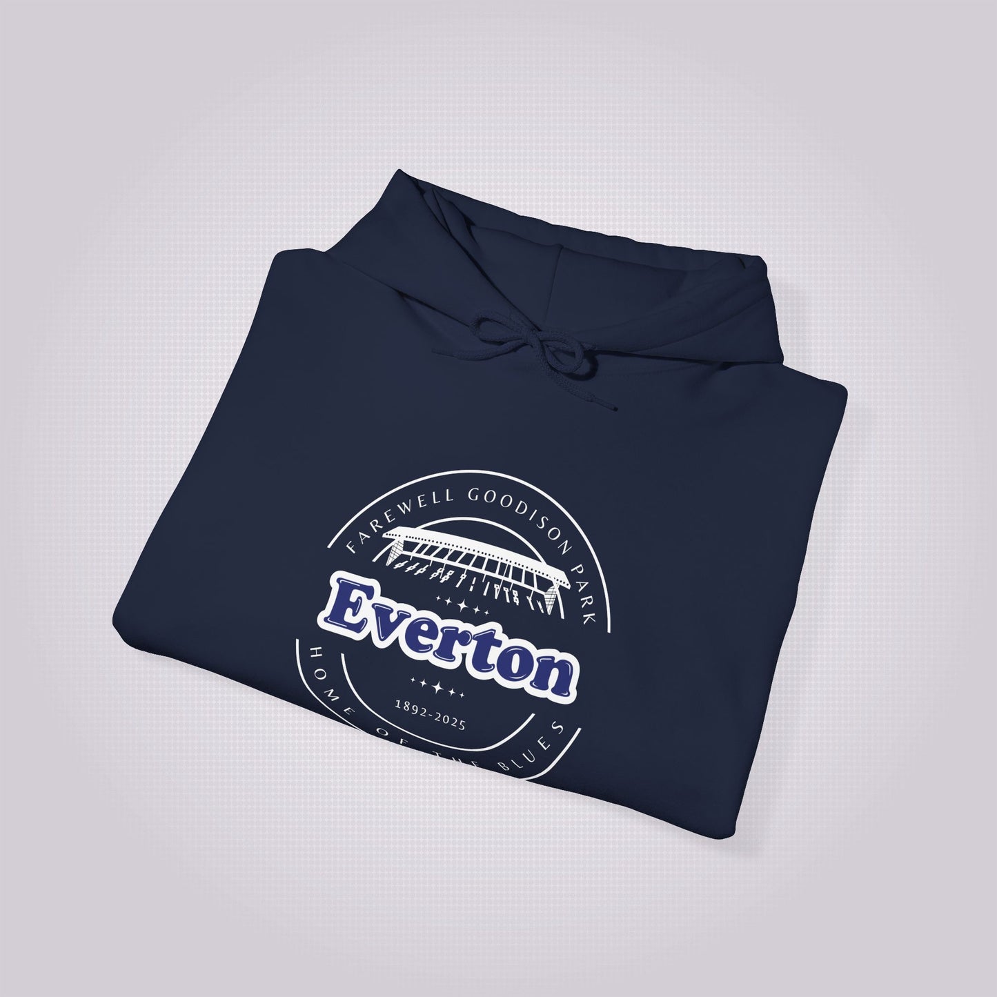 Navy hoodie folded and placed at a slight right angle on a light grey dotted background