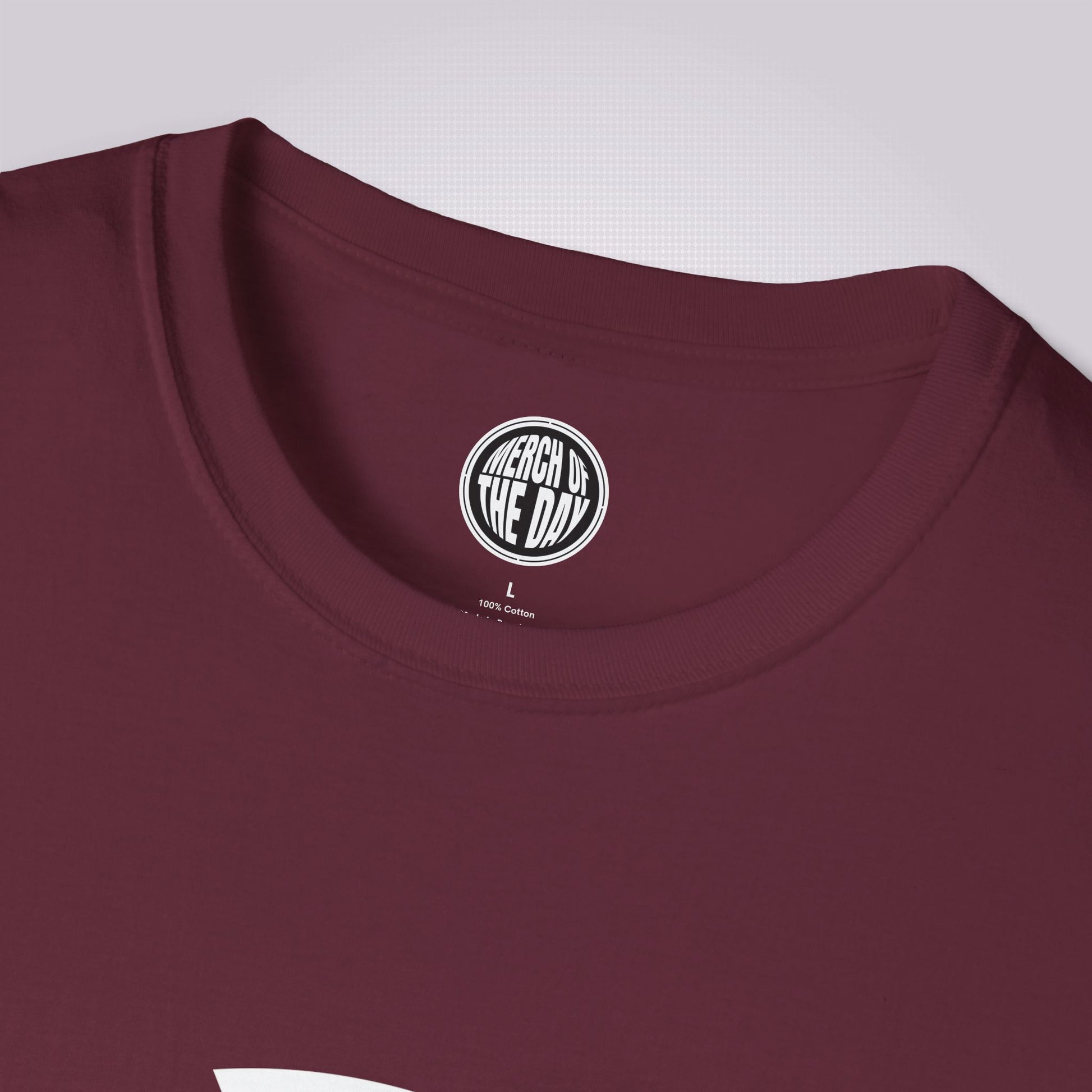 Close up of maroon t shirt showing the crew neckline and clothing brand logo on the inner label