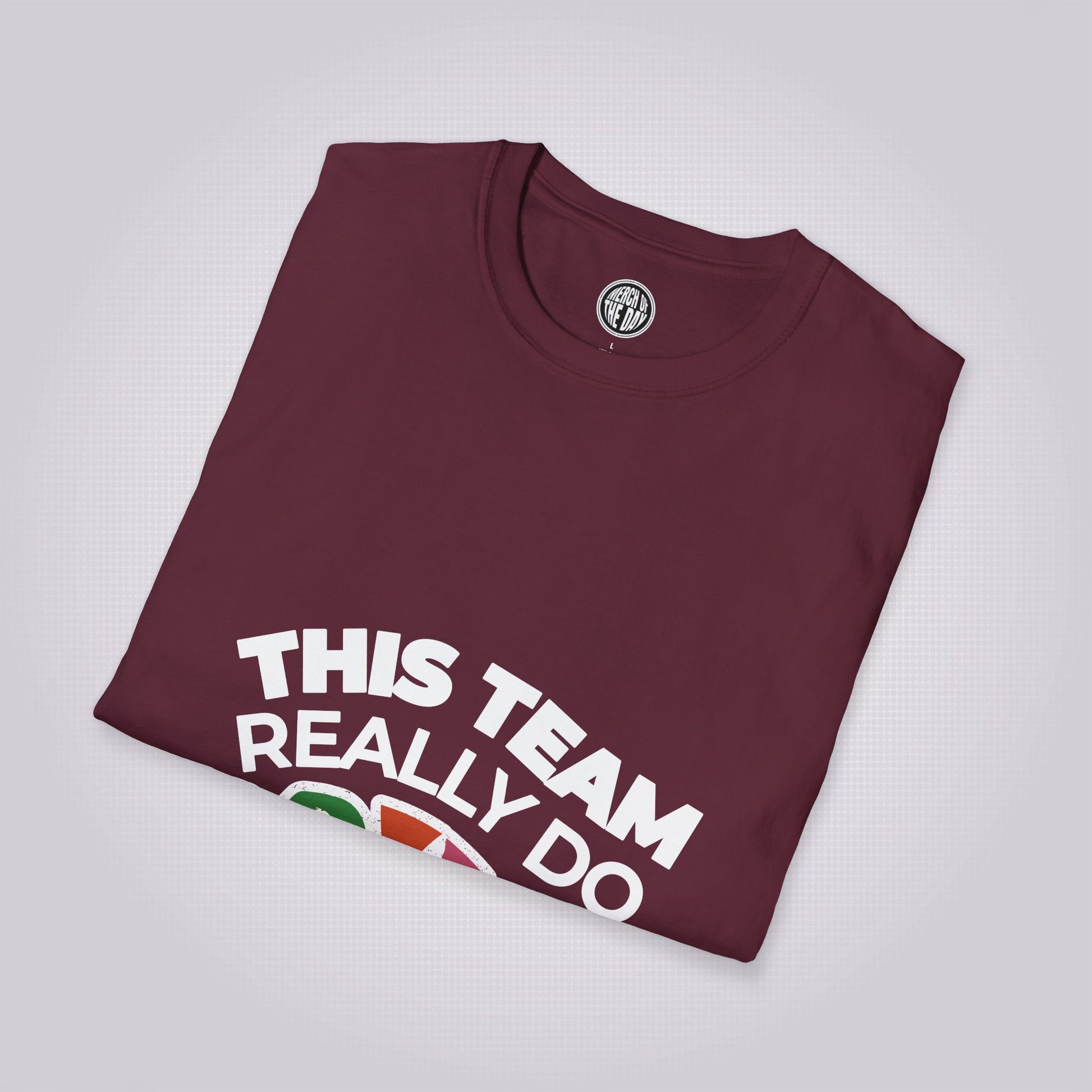 Maroon t shirt laid at a slight right angle on a light grey dotted background