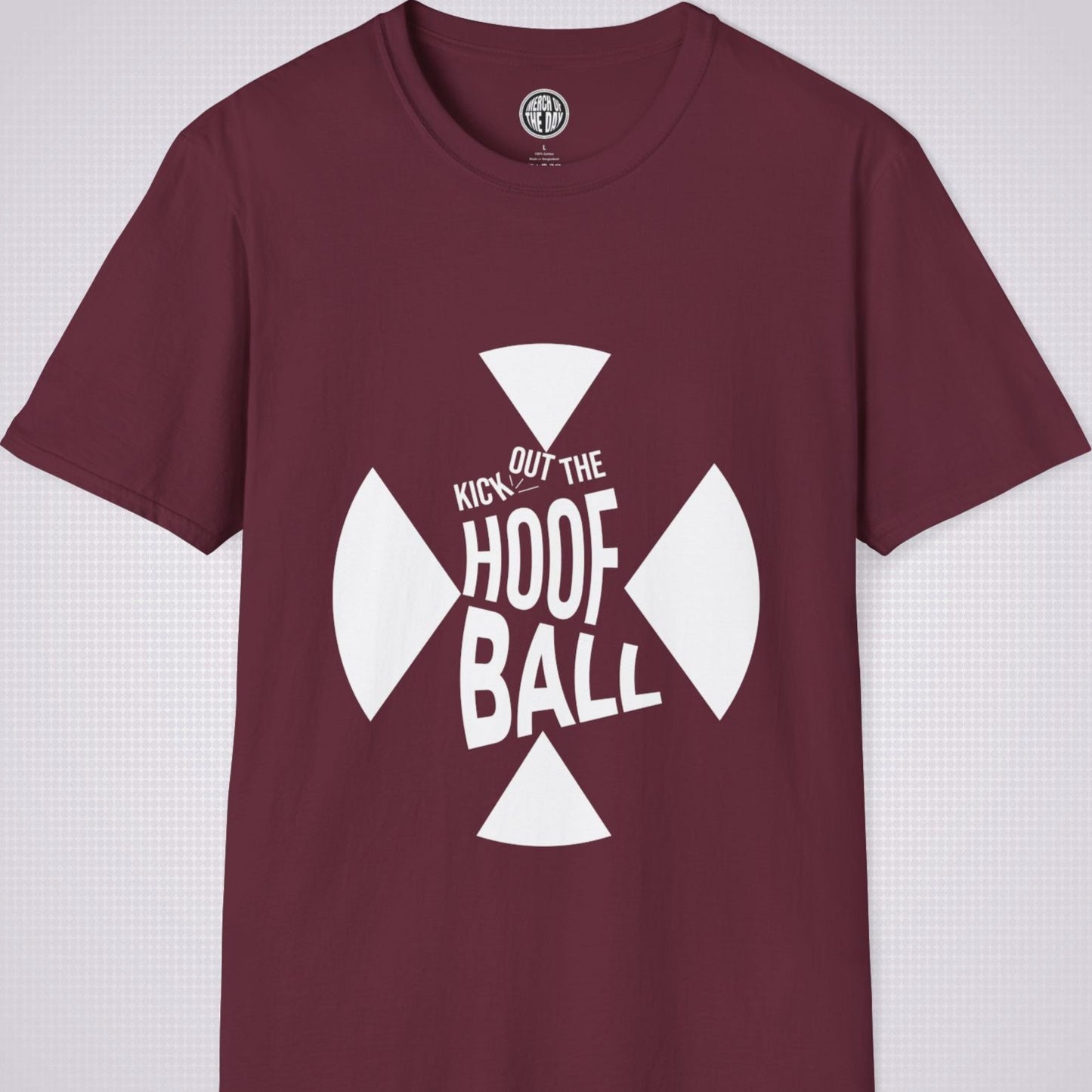 Maroon t shirt on a light grey dotted background. The t shirt has a graphic of a giant X within that are the words 'Kick Out The Hoof Ball' 