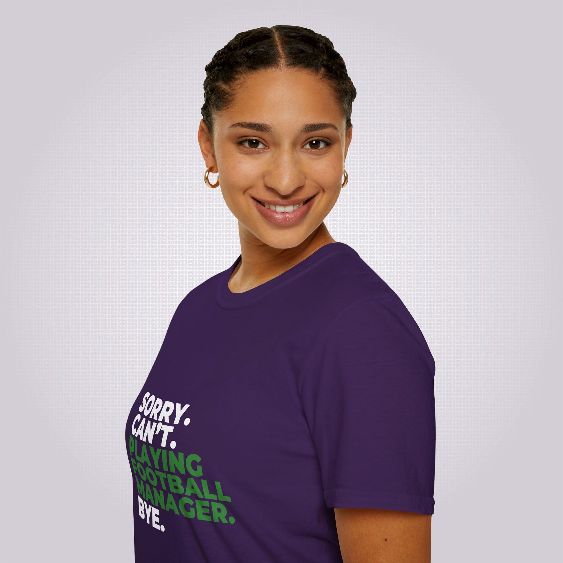 Side profile shot of a young mixed race woman who is smiling at the camera but her body is facing to the left as you look she is wearing the purple t shirt