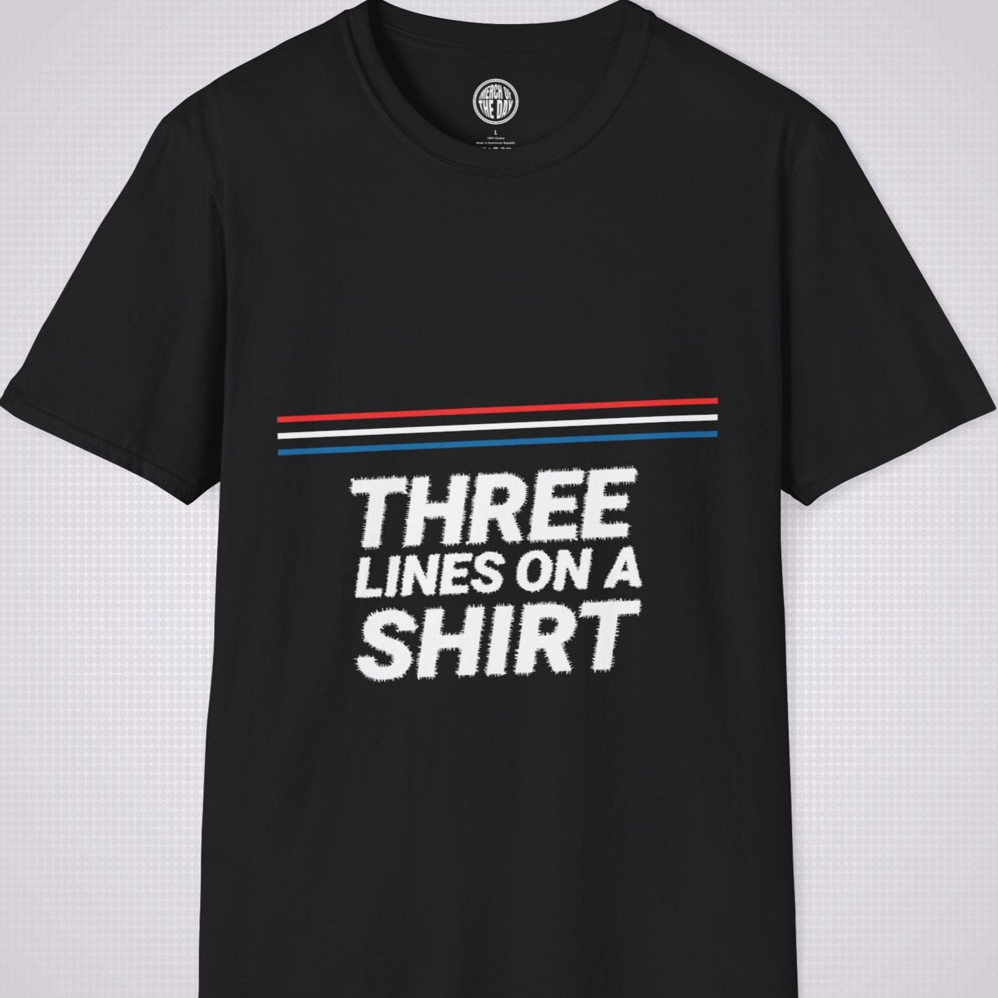 Black t shirt on a light grey dotted backdrop with a red white and blue diagonal line pattern with the words three lines on a shirt under that