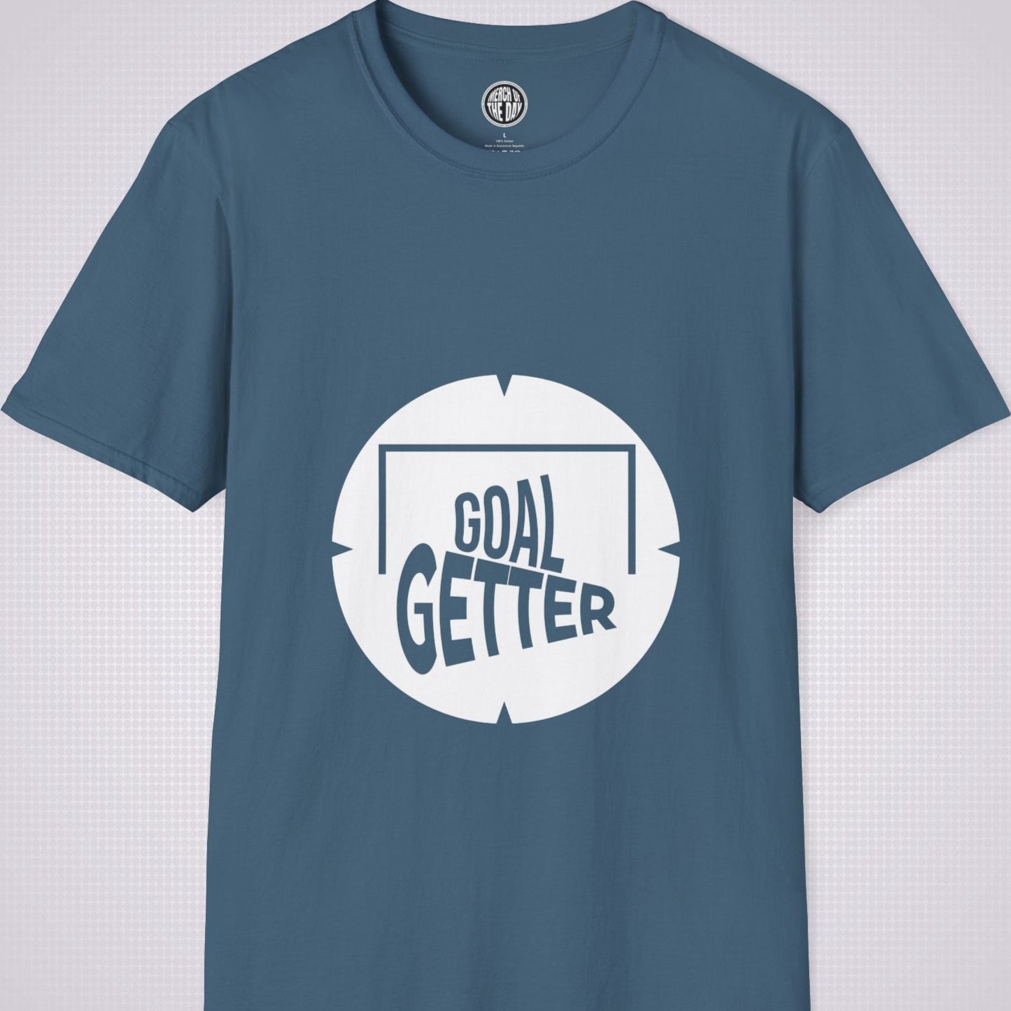 Indigo Blue t shirt on a light grey patterned background the artwork on the shirt shows a circle with segments in all 4 corners symbolising a target and a football  and the words read goal getter within a goal frame 