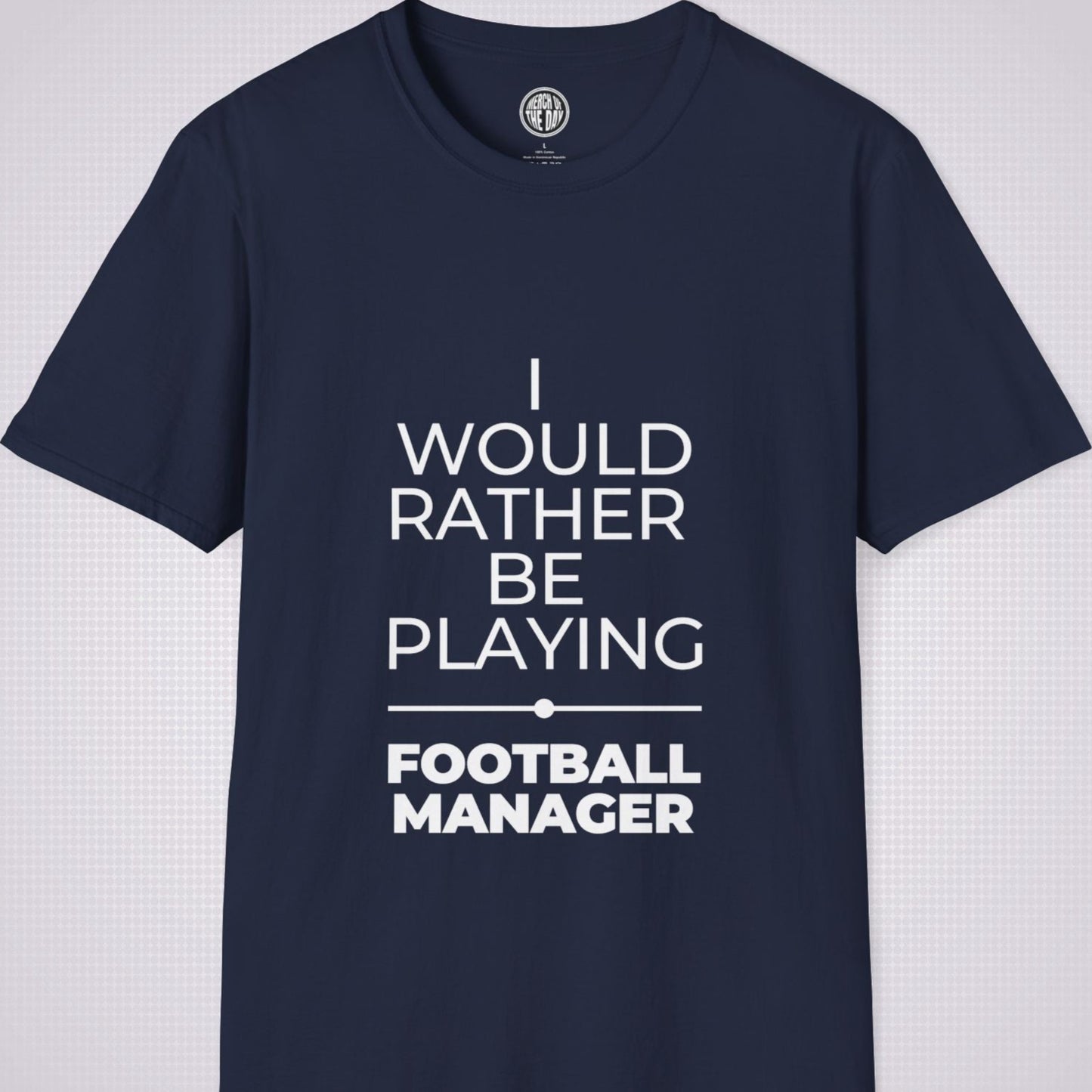 Navy t shirt on a light grey patterned backdrop with text on the shirt saying I would rather be playing football manager