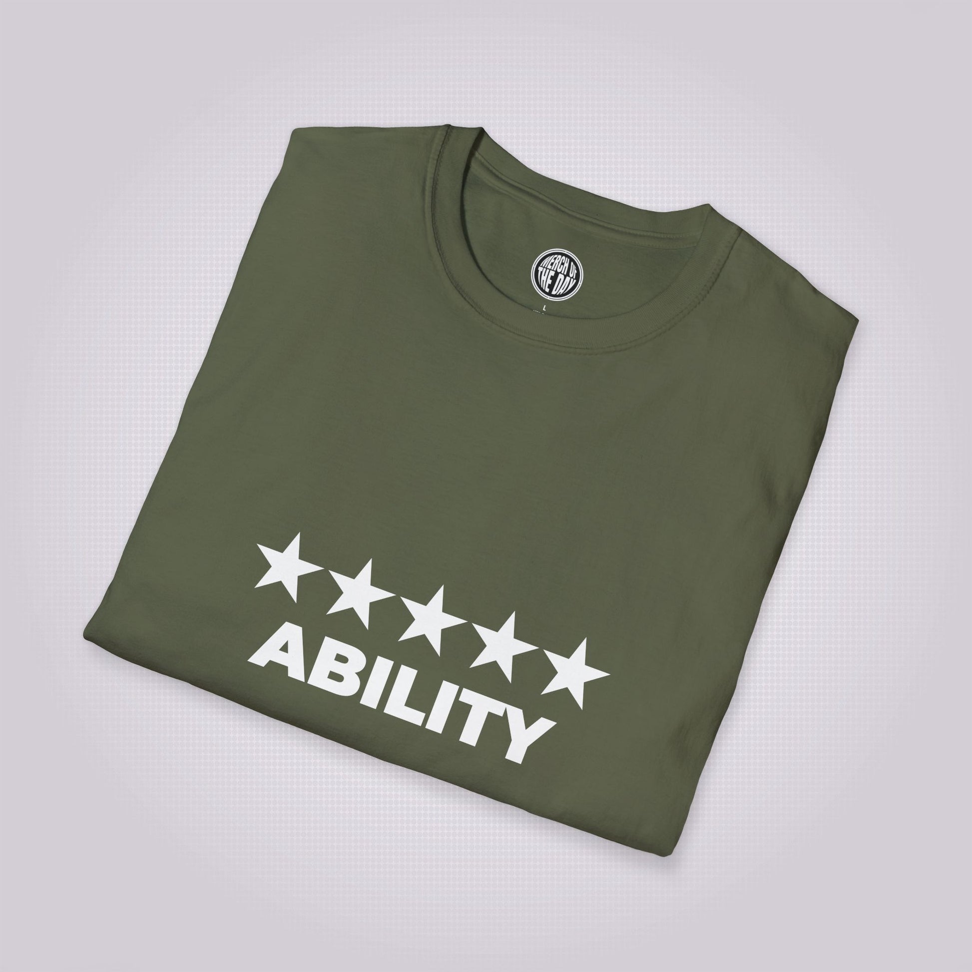 Military Green t shirt folded and placed at a right angle on a light grey dotted background