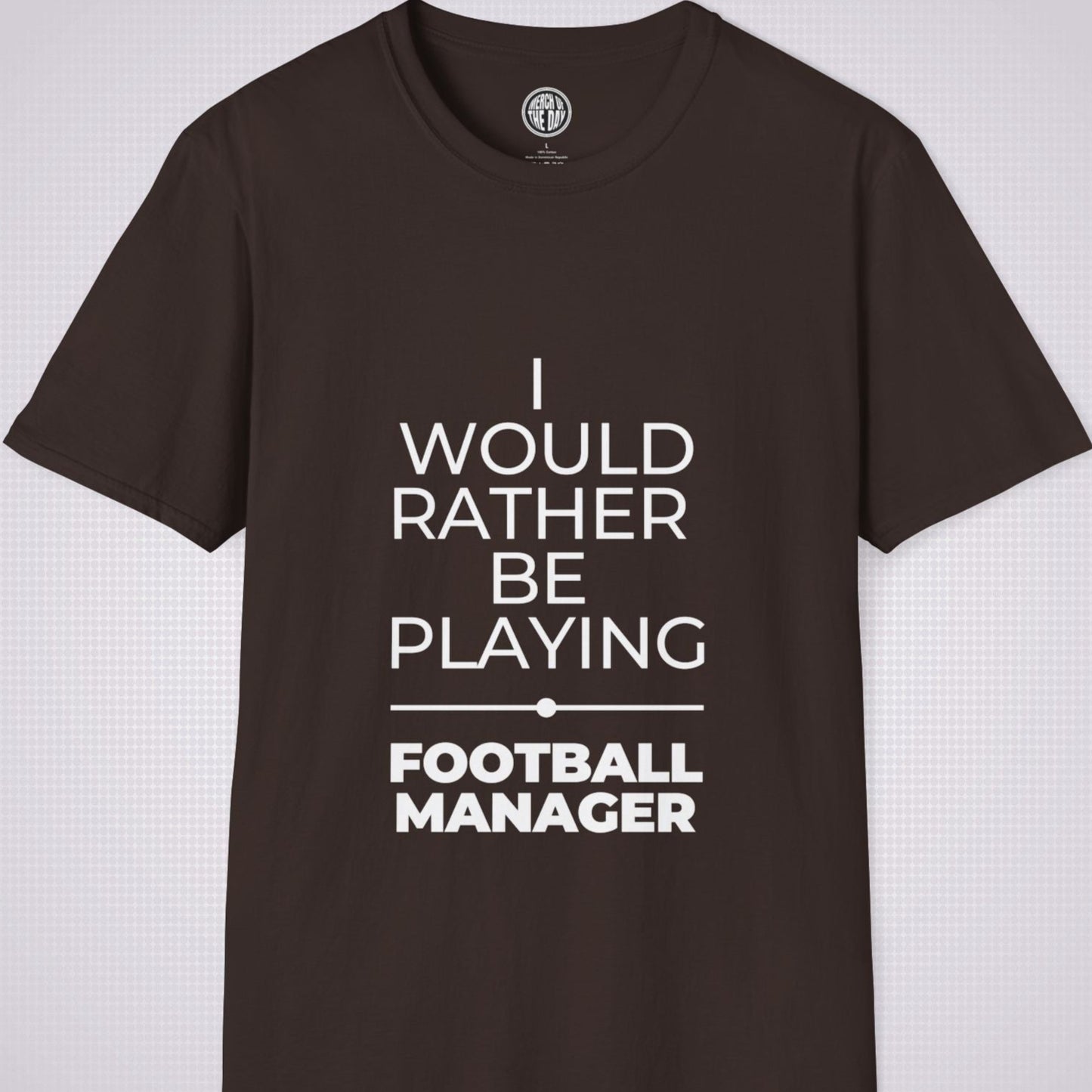 Brown t shirt on a light grey patterned backdrop with text on the shirt saying I would rather be playing football manager