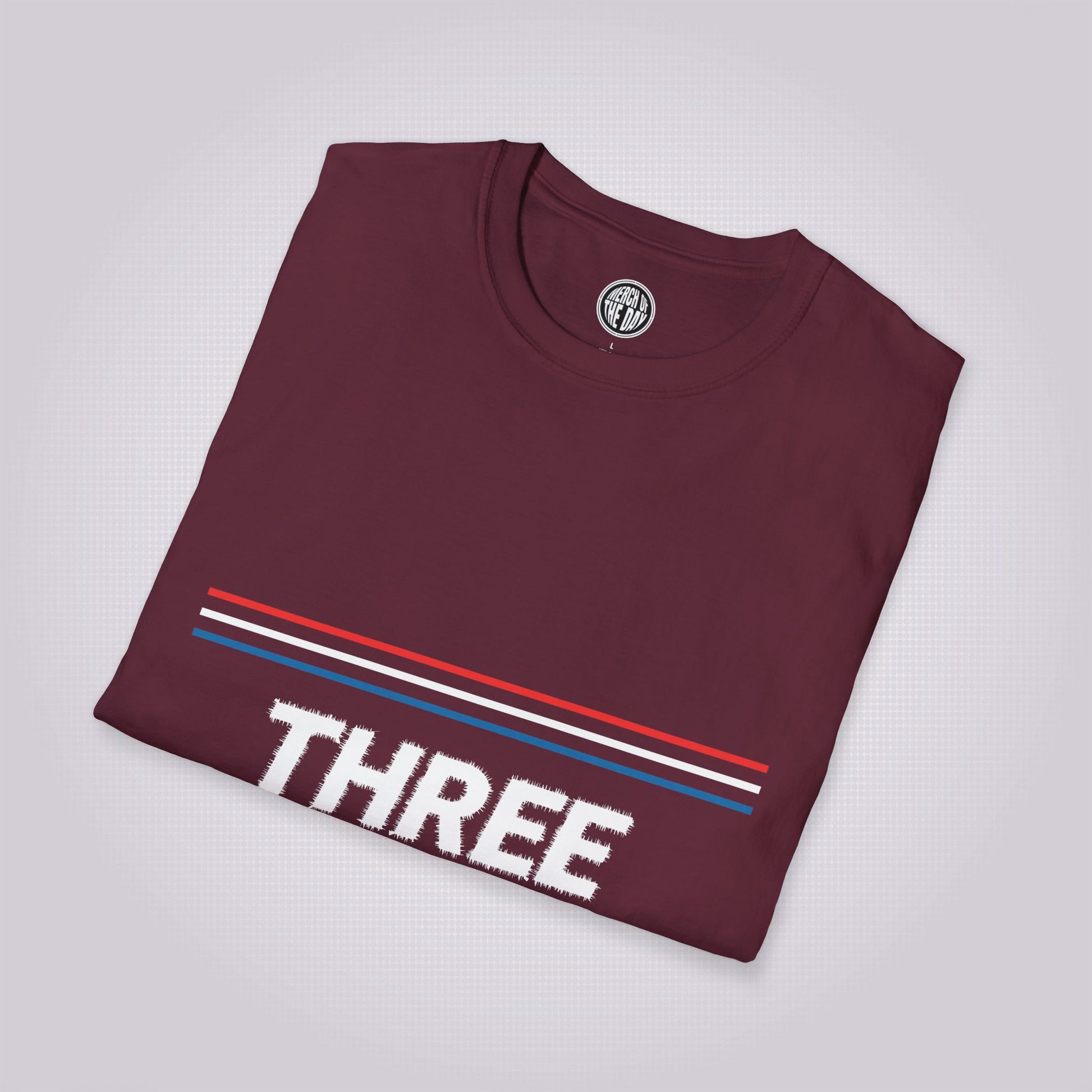 Maroon t shirt placed at a slight right angle  placed onto a dotted light grey background